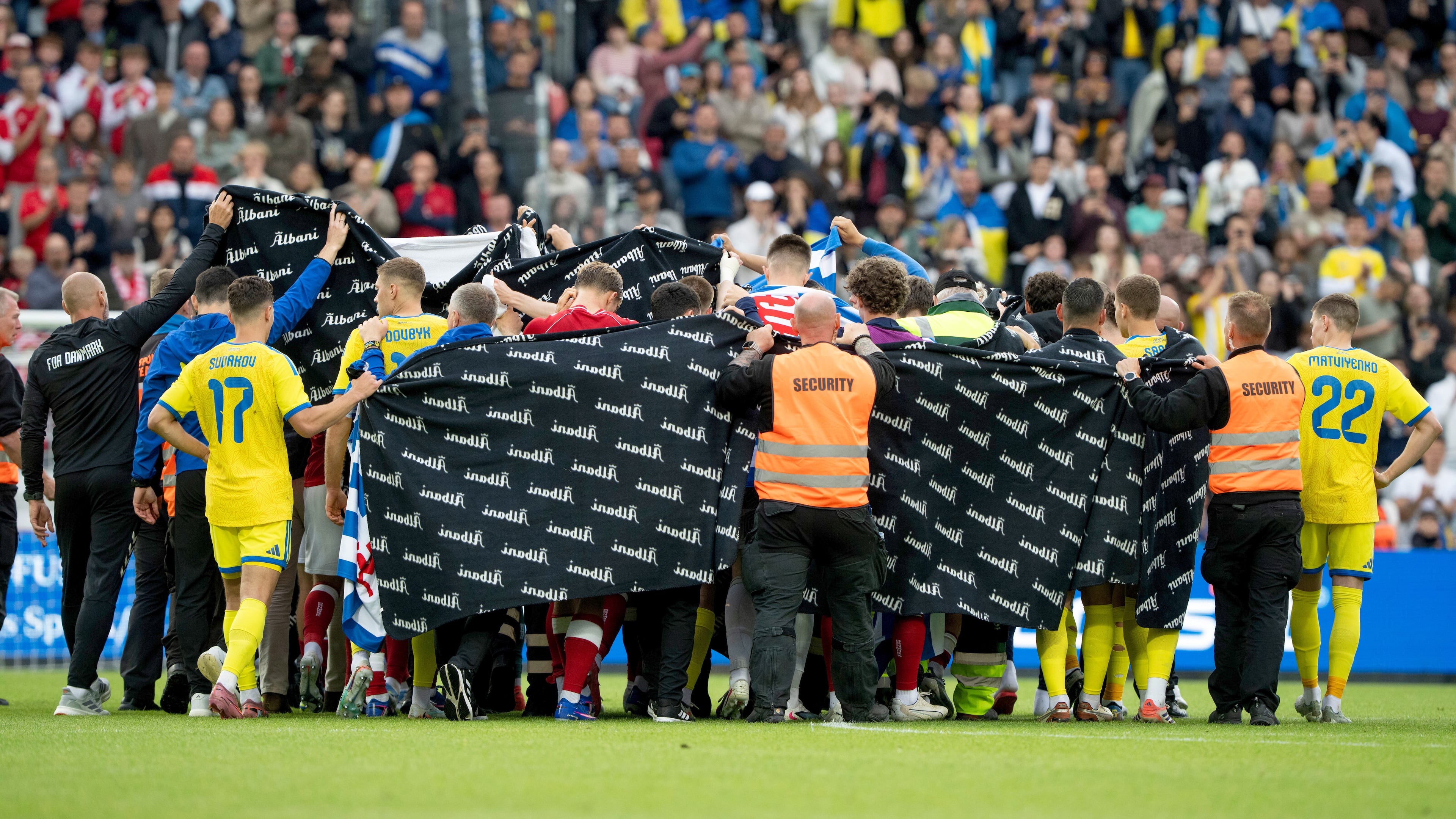 Denmark's and Ukraine's players accompany Christian Eriksen to a waiting ambulance during the international friendly soccer match between Denmark and Ukraine in Odense, Denmark, Sunday, June 7, 2026, after Eriksen has collapsed on the field again while playing for Denmark’s national team. (Bo Amstrup/Ritzau Scanpix via AP)