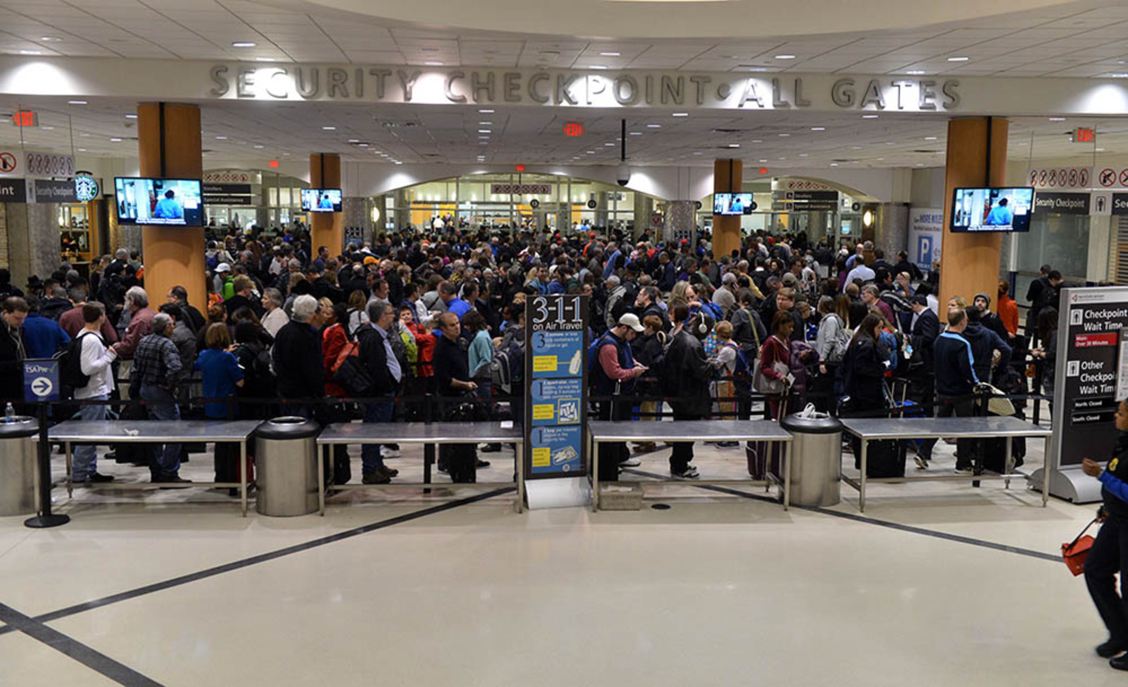 Travelers wait to go through the main security checkpoint at Hartsfield Jackson International Airport Thursday afternoon. Both Delta Air Lines and Southwest Airlines had said they planned to rebuild toward normal schedules Thursday afternoon after two days of minimal operations.