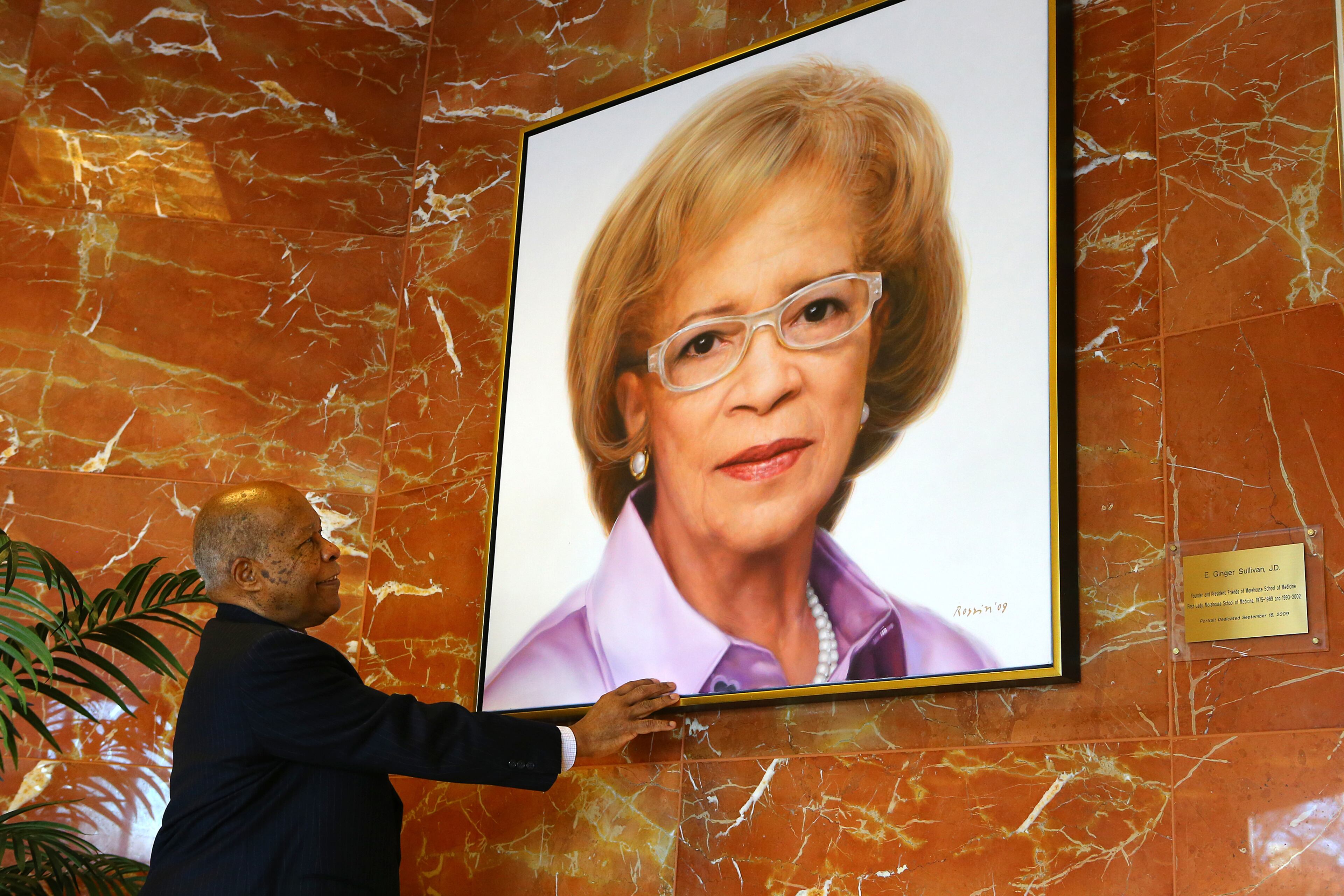 Dr. Louis W. Sullivan, the founding dean and first president of Morehouse School of Medicine, fondly looks over a painting of his wife E. Ginger Sullivan, JD, Founder and President Friends of Morehouse School of Medicine, in the lobby of the building bearing his name, the Louis W. Sullivan National Center for Primary Care, on Tuesday, Jan. 21, 2014, in Atlanta. Sullivan said " I was pleased they named a building after me, but I was even more pleased they named the atrium after my wife." CURTIS COMPTON / CCOMPTON@AJC.COM