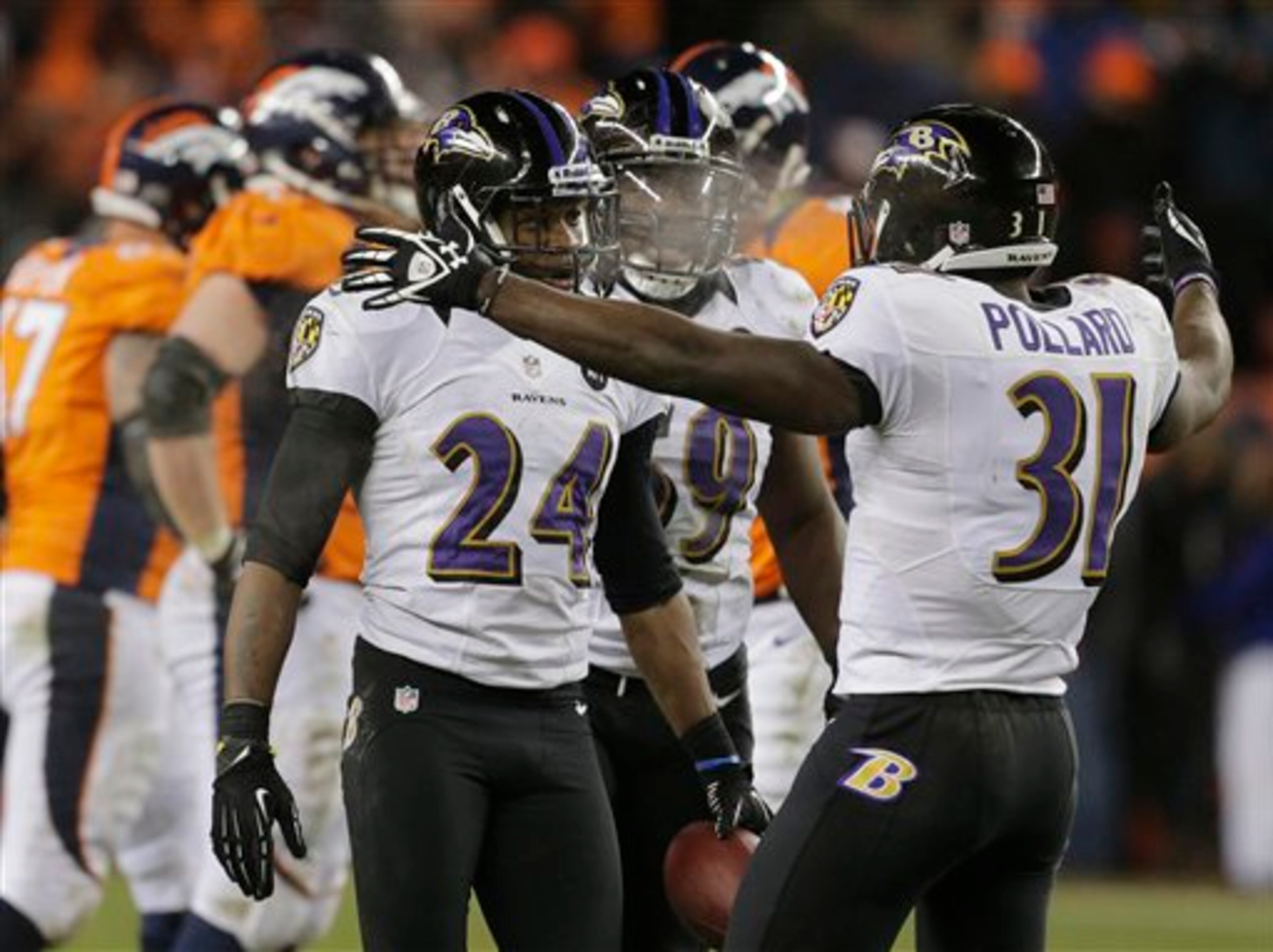 Baltimore Ravens cornerback Corey Graham (24) is congratulated by Baltimore Ravens strong safety Bernard Pollard (31) after intercepting a pass against the Denver Broncos in overtime of an AFC divisional playoff NFL football game, Saturday, Jan. 12, 2013, in Denver. The Ravens won 38-35. (AP Photo/Charlie Riedel)