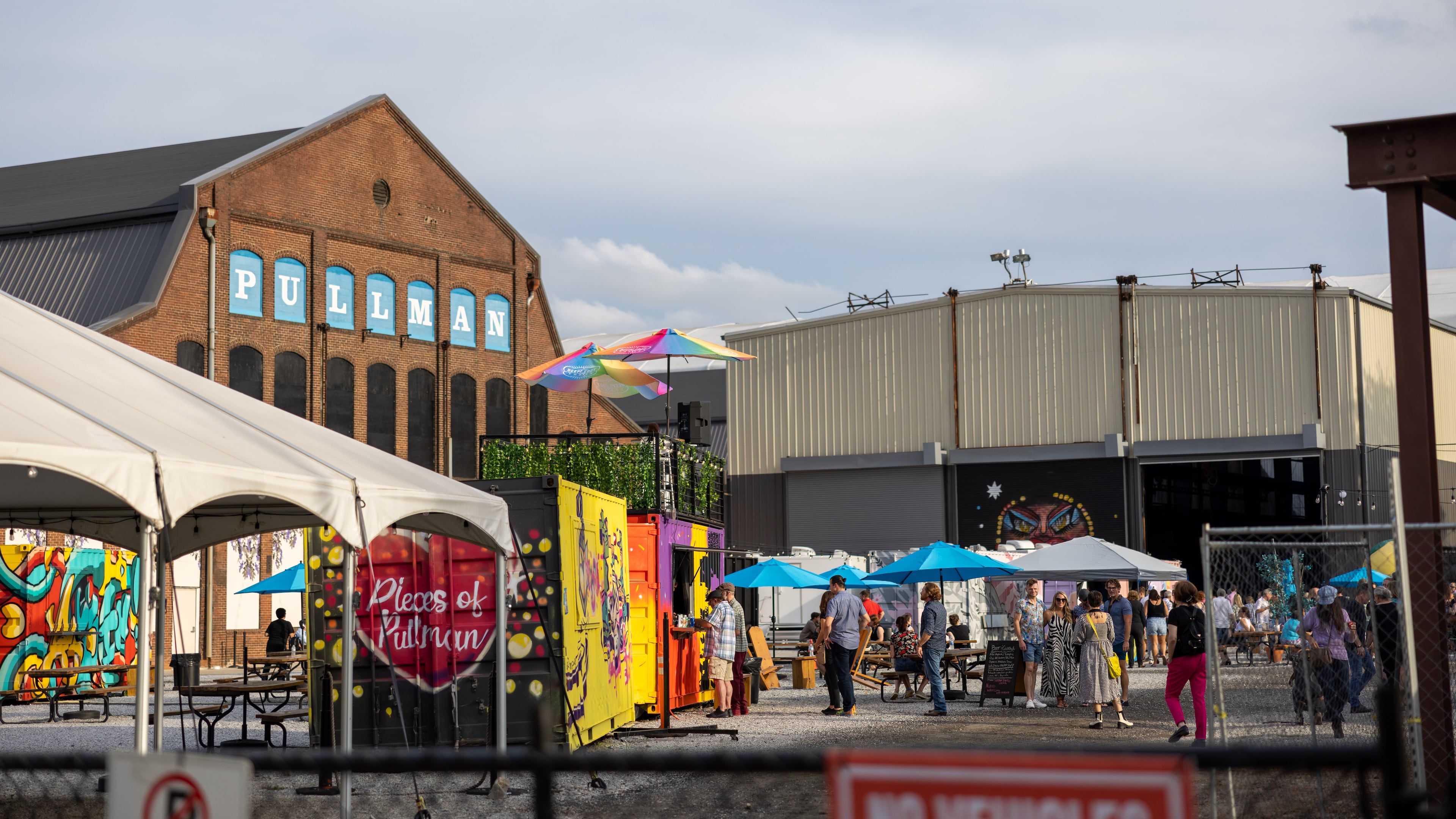 People walking around and buying from food trucks at Pratt Pullman Yard on August 20, 2022