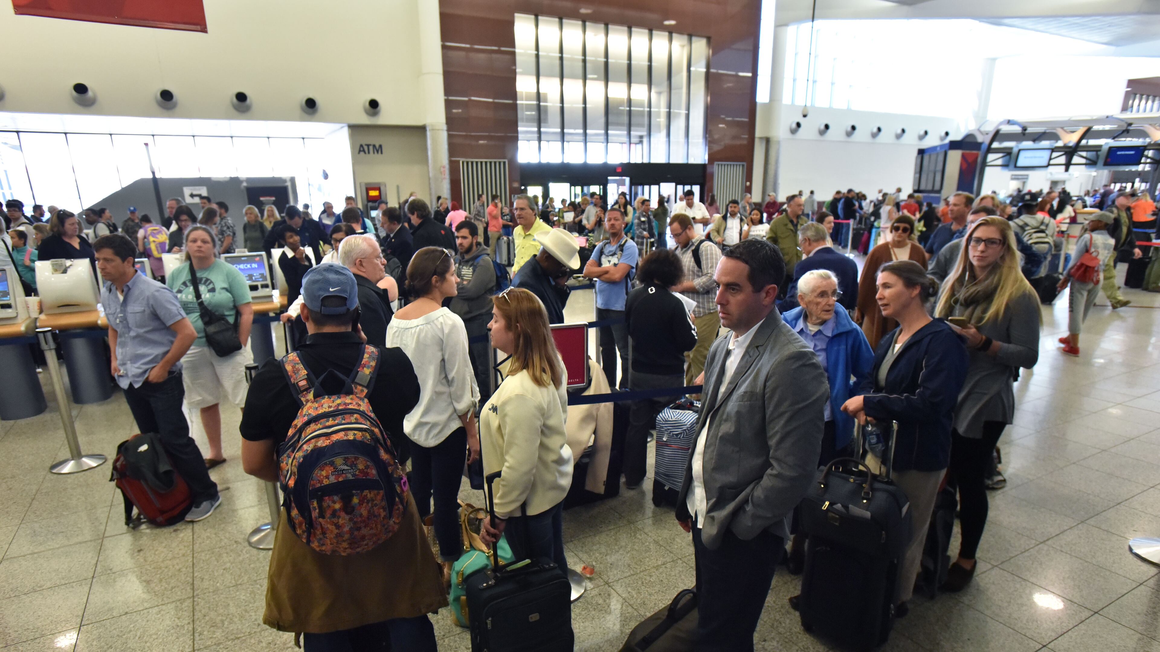 Delta passengers wait in line in hopes of catching their flight out of Hartsfield-Jackson Atlanta International Airport on Friday, April 7, 2017. HYOSUB SHIN / HSHIN@AJC.COM