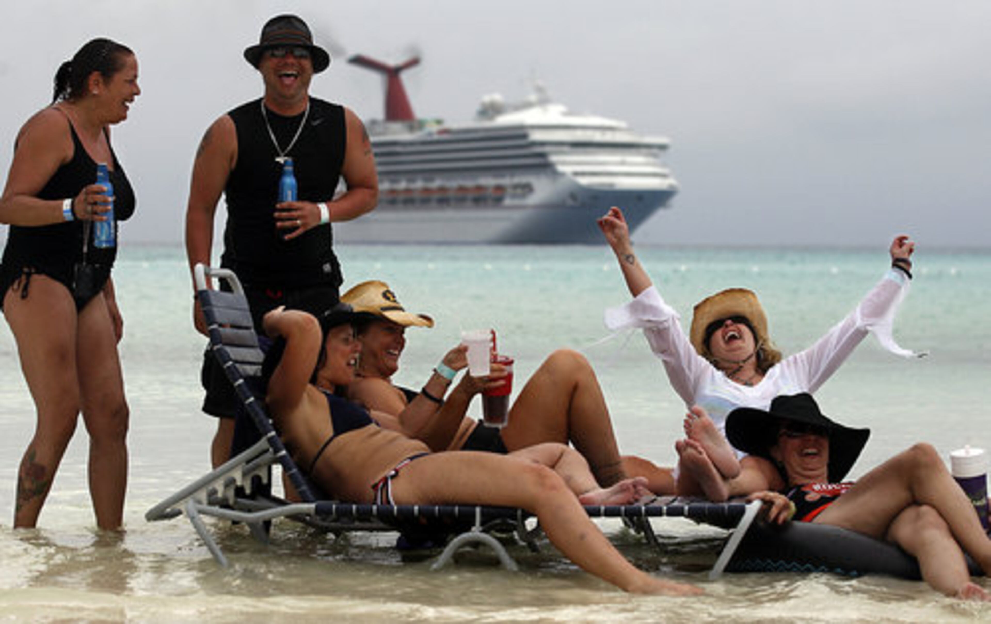 Fans relax on the beach as the music plays.