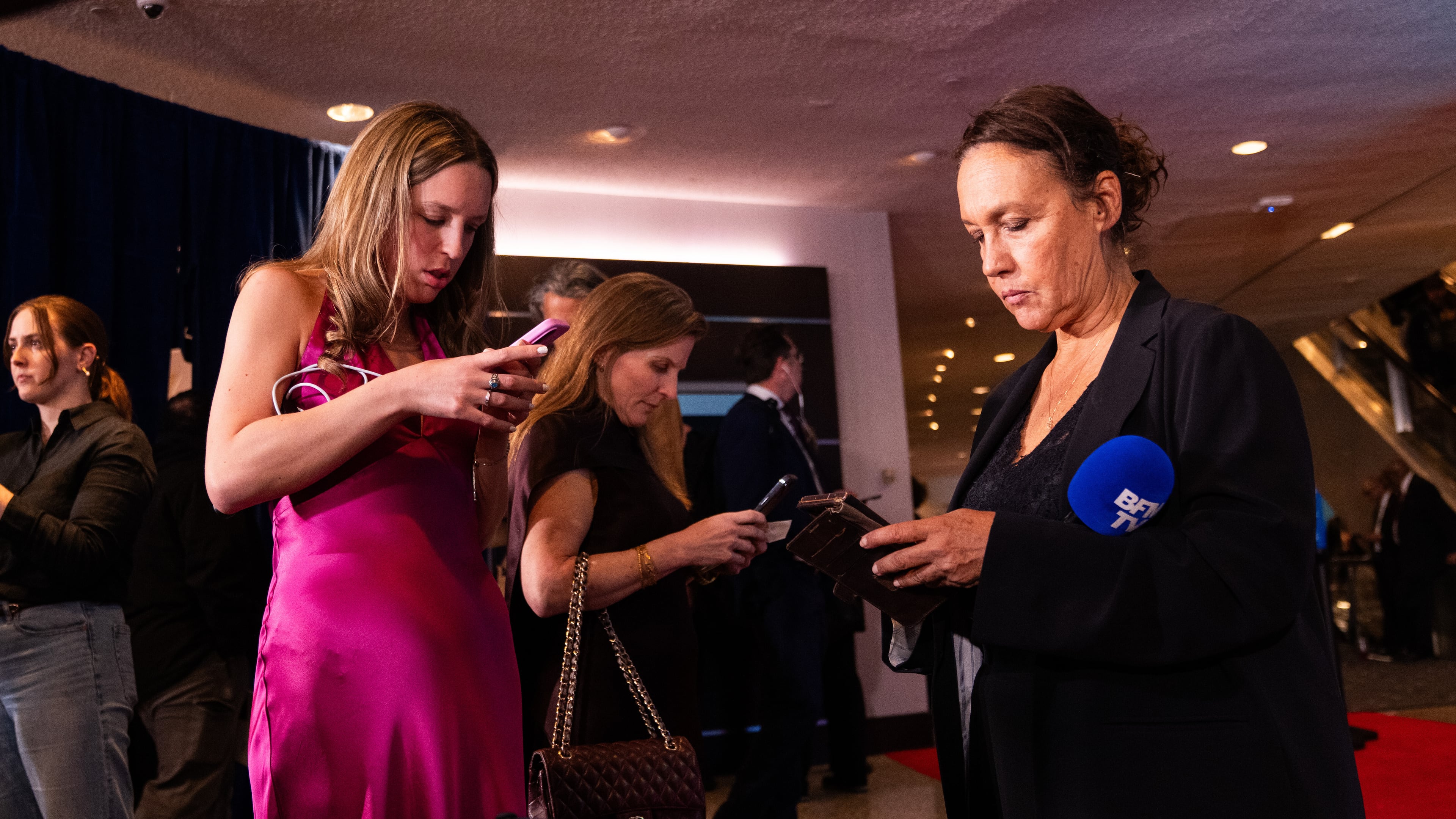 Journalists that were in attendance for the White House Correspondents Dinner prepare for a press briefing at the Washington Hilton following an incident that disrupted the event, Saturday, April 25, 2026, in Washington. (AP Photo/Allison Robbert)