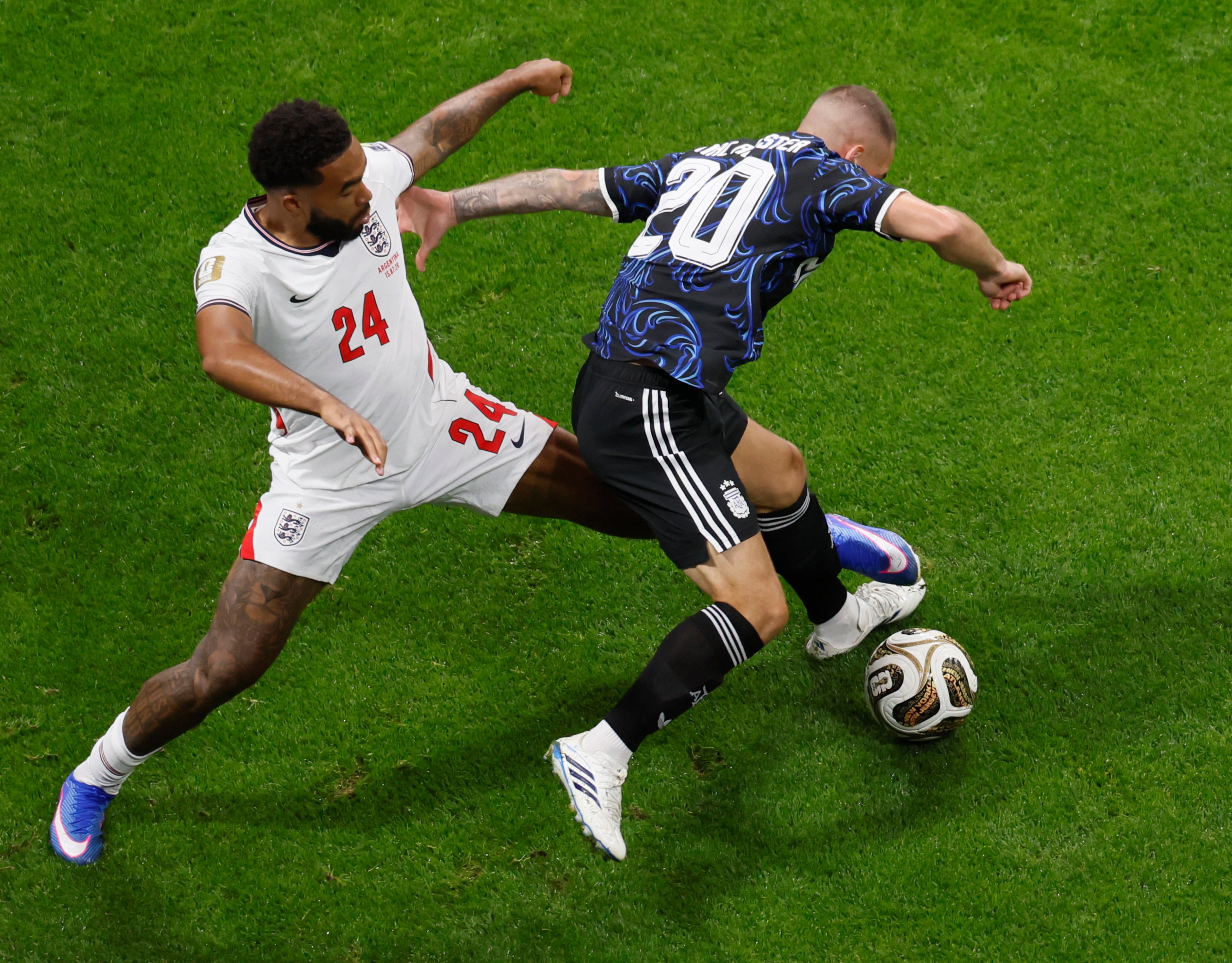 England's Reece James, left, battles Argentina's Alexis Mac Allister for ball during first half of Argentina vs. England FIFA World Cup Semifinal match at Atlanta Stadium (Mercedes-Benz Stadium) on Wednesday, July 15, 2026. (Miguel Martinez/AJC)