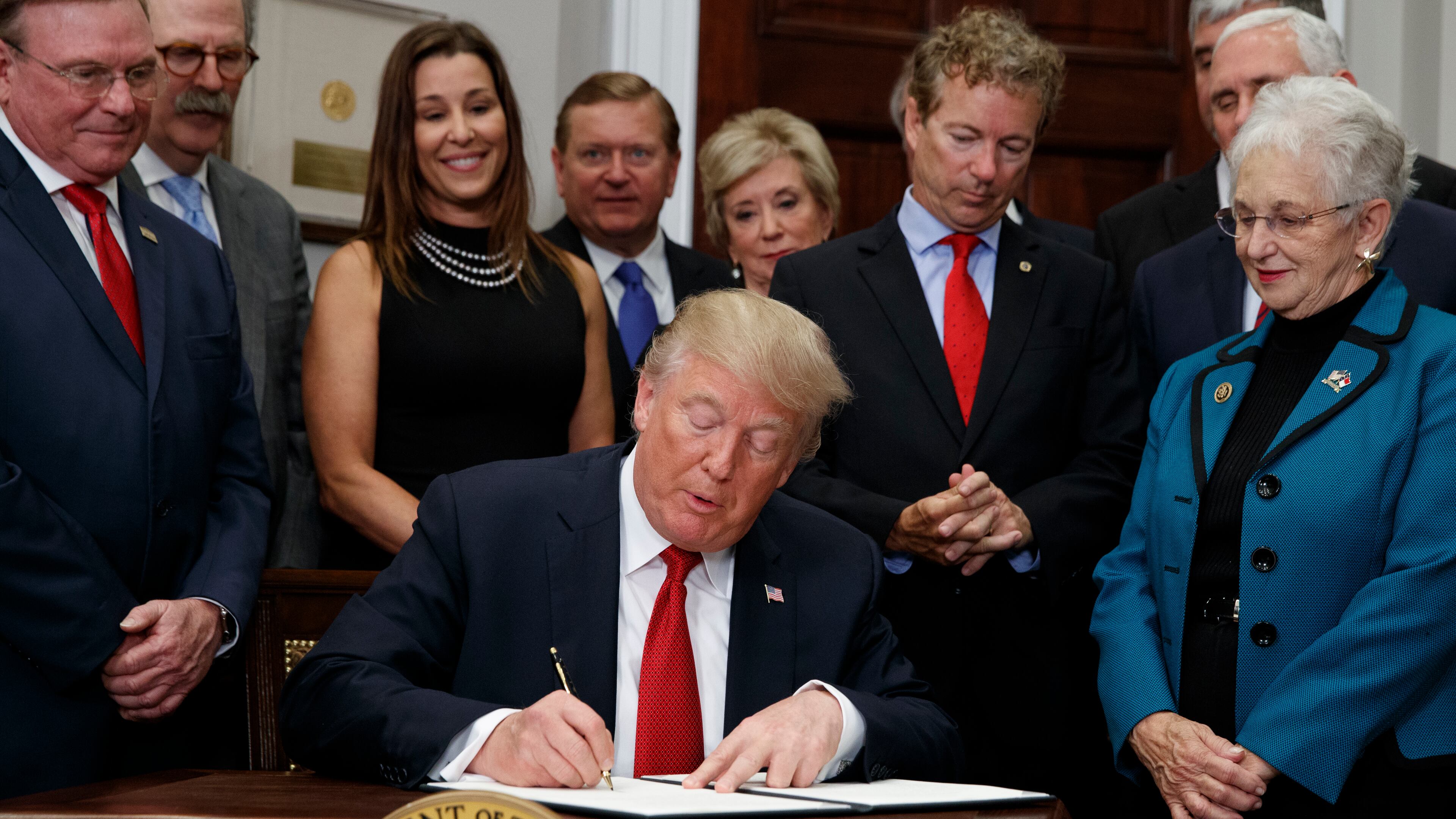 President Donald Trump signs an executive order on health care in the Roosevelt Room of the White House, Thursday, Oct. 12, 2017, in Washington. (AP Photo/Evan Vucci)