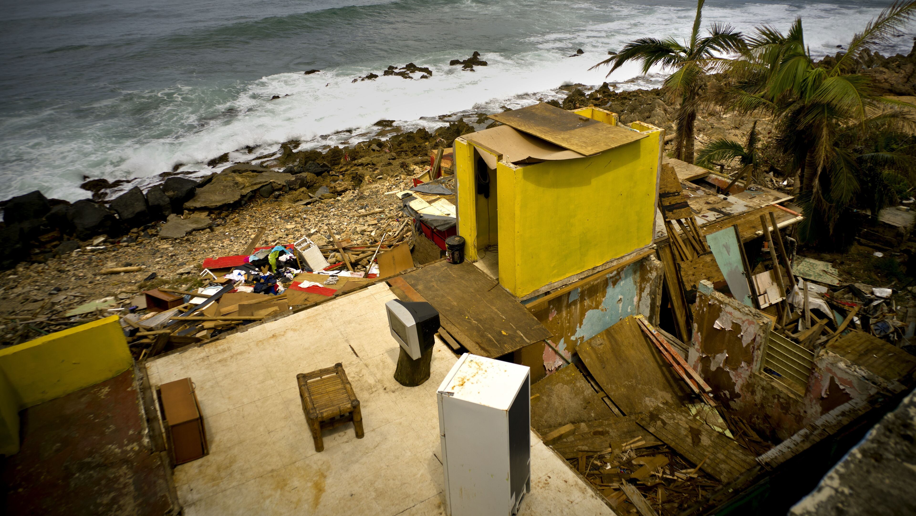 This Oct. 5, 2017 photo shows what is left of Roberto Figueroa's home in the aftermath of Hurricane Maria in the seaside slum La Perla, San Juan, Puerto Rico. Tourism officials recently met with La Perla local leader and asked her how long it would take before La Perla could welcome tourists again. âWe told them to give us a month or two, that we were going to rise up again,â Yashira Gomez said. âWe are looking for any kind of help ... so that tourists can come back and see that La Perla is still pretty, that itâs on its feet and that weâre working hard to make it shine like before.â (AP Photo/Ramon Espinosa)