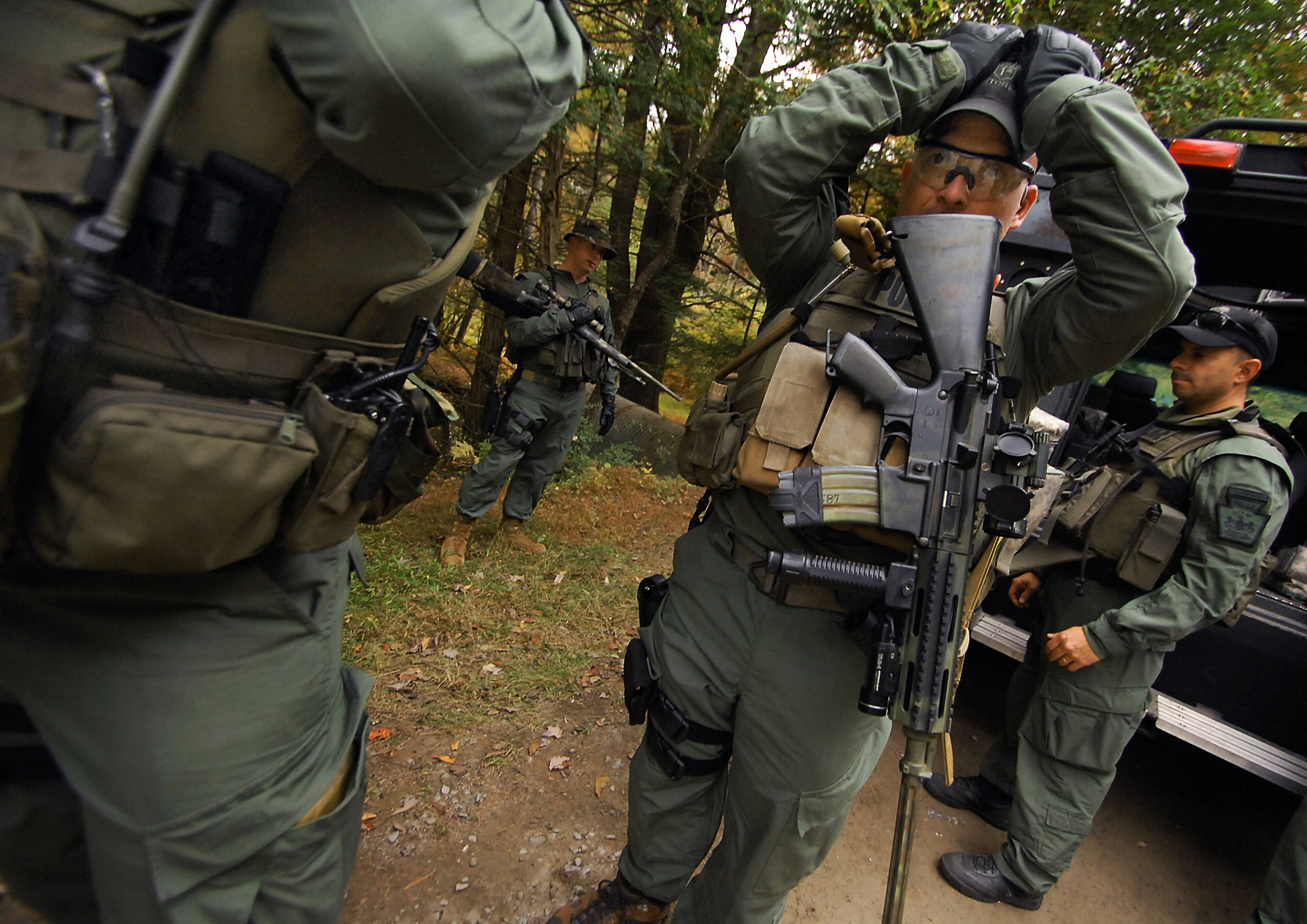 Members of the Scranton, Pa., Police Special Operations Group, prepare to search the woods, Thursday, Oct. 2, 2014, in Barrett Township near Canadensis, Pa., for suspected killer Eric Frein. A massive manhunt has been underway for 31-year-old Frein in the rugged terrain of the Pocono Mountains since Sept. 12. The self-taught survivalist is charged with killing Cpl. Bryon Dickson and seriously wounding Trooper Alex Douglass outside their barracks in Blooming Grove. (AP Photo/Scranton Times & Tribune, Butch Comegys) WILKES BARRE TIMES-LEADER OUT; MANDATORY CREDIT