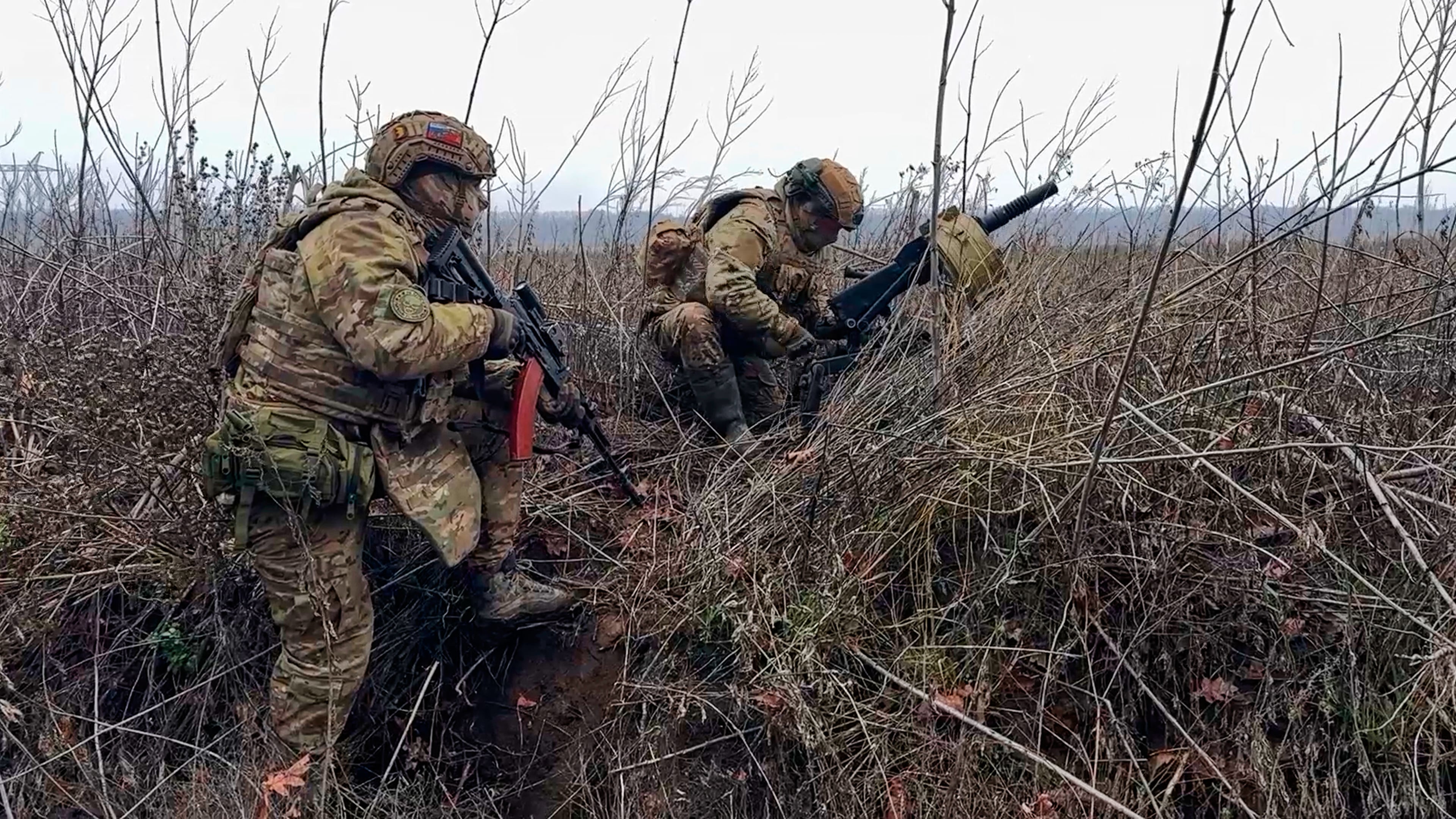 In this image made from video provided by Russian Defense Ministry Press Service on Tuesday, March 31, 2026, Russian soldiers prepare to fire a grenade launcher towards Ukrainian positions on an undisclosed location in Ukraine. (Russian Defense Ministry Press Service via AP)