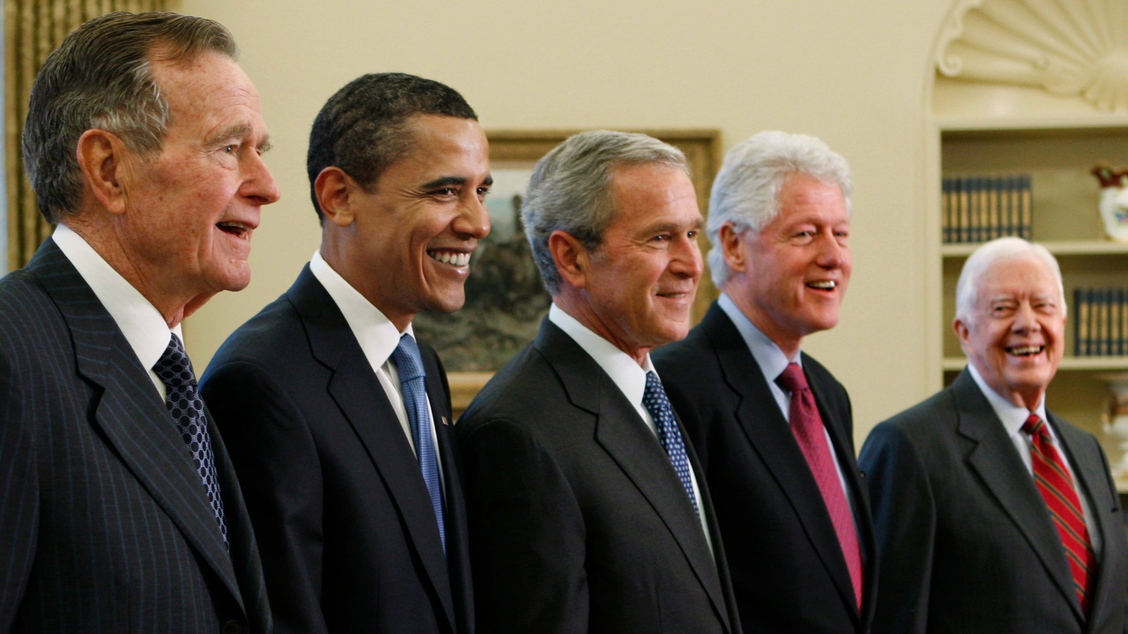 FILE - President George W. Bush, center, poses with President-elect Barack Obama, and former presidents, from left, George H.W. Bush, left, Bill Clinton and Jimmy Carter, right, Jan. 7, 2009, in the Oval Office of the White House in Washington. (AP Photo/J. Scott Applewhite, File)
