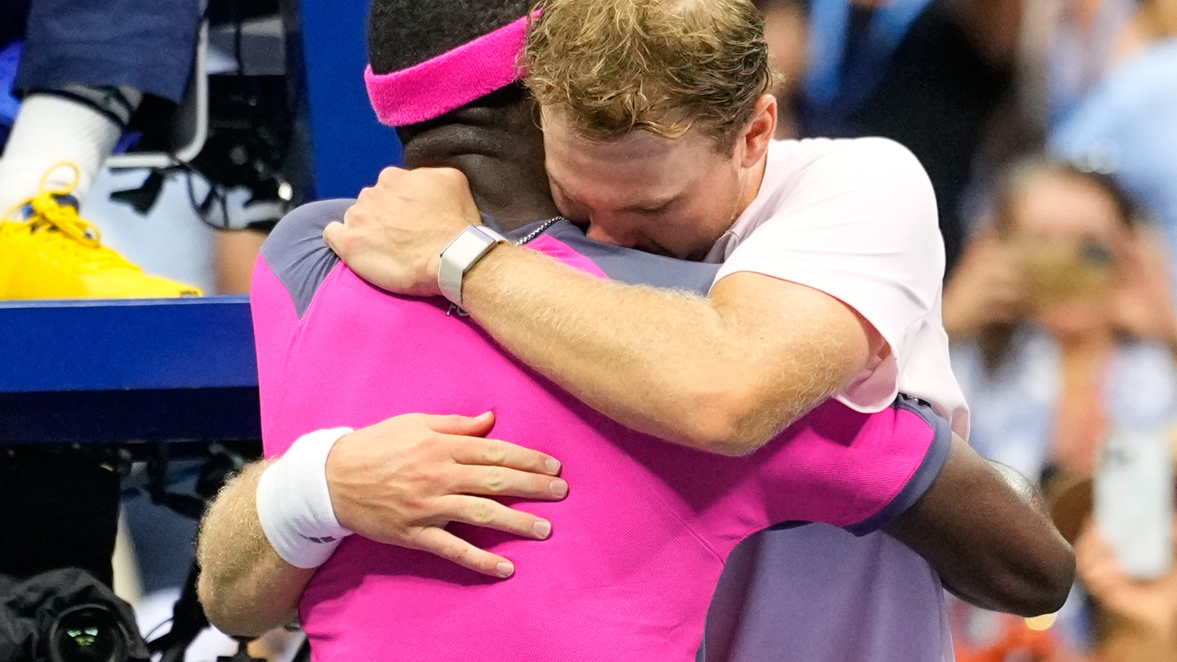 Frances Tiafoe, left, of the United States, and Alex Michelsen, of the United States, embrace after Tiafoe won their match in the quarterfinal round of the U.S. Open tennis championships, Tuesday, Sept. 8, 2026, in New York. (AP Photo/Yuki Iwamura) CORRECTION: Corrects Tiafoe to left, not right.