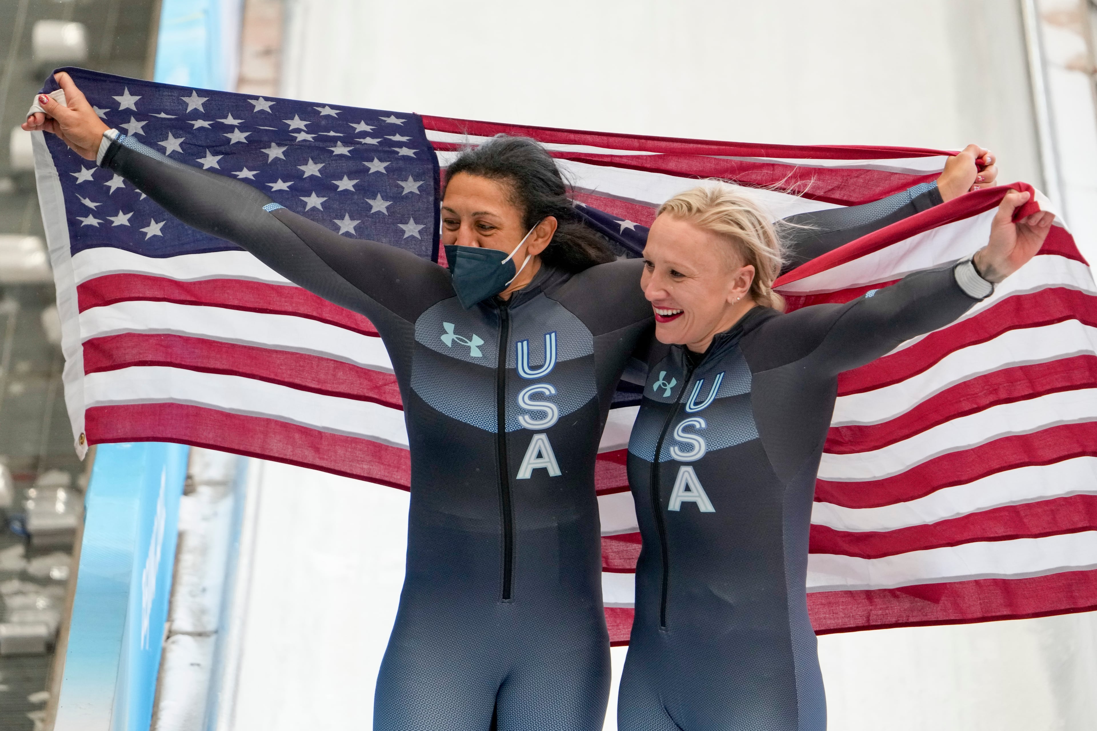 Elana Meyers Taylor (left) and teammate Kaillie Humphries celebrate after the women's monobob at the 2022 Winter Olympics in Beijing. (Pavel Golovkin/AP)