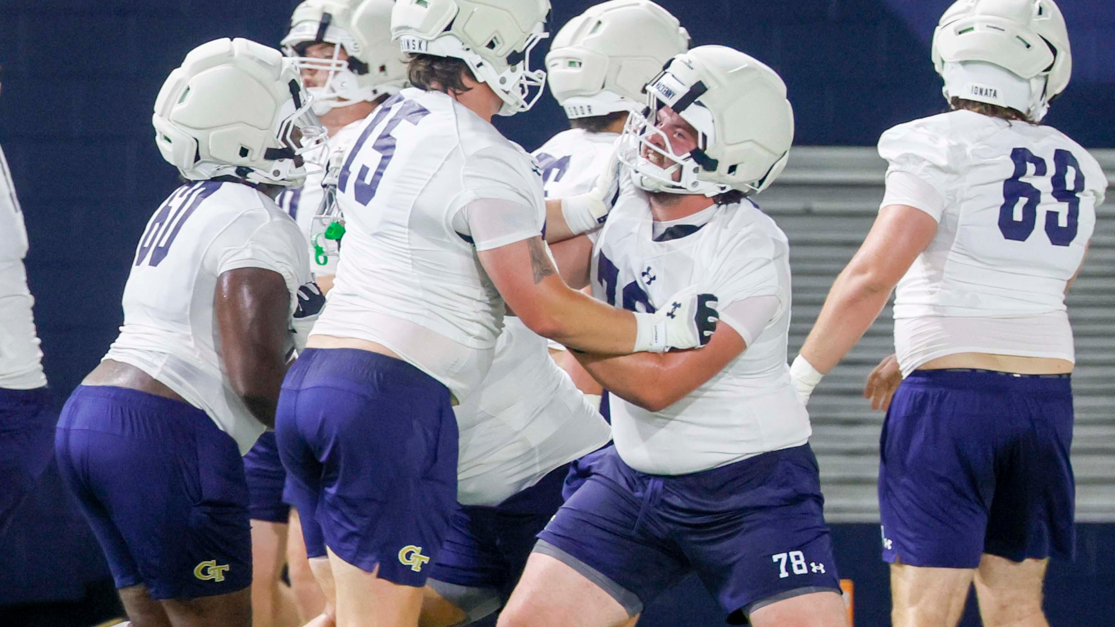 Georgia Tech offensive lineman Ethan Mackenny (second from right), participates in a drill with lineman Andrew Rosinski (second from left) during the first day of football practice at Rose Bowl Field and the Mary and John Brock Football Practice Facility, at Georgia Tech in Atlanta, Monday, Aug. 3, 2026. (Miguel Martinez/AJC)