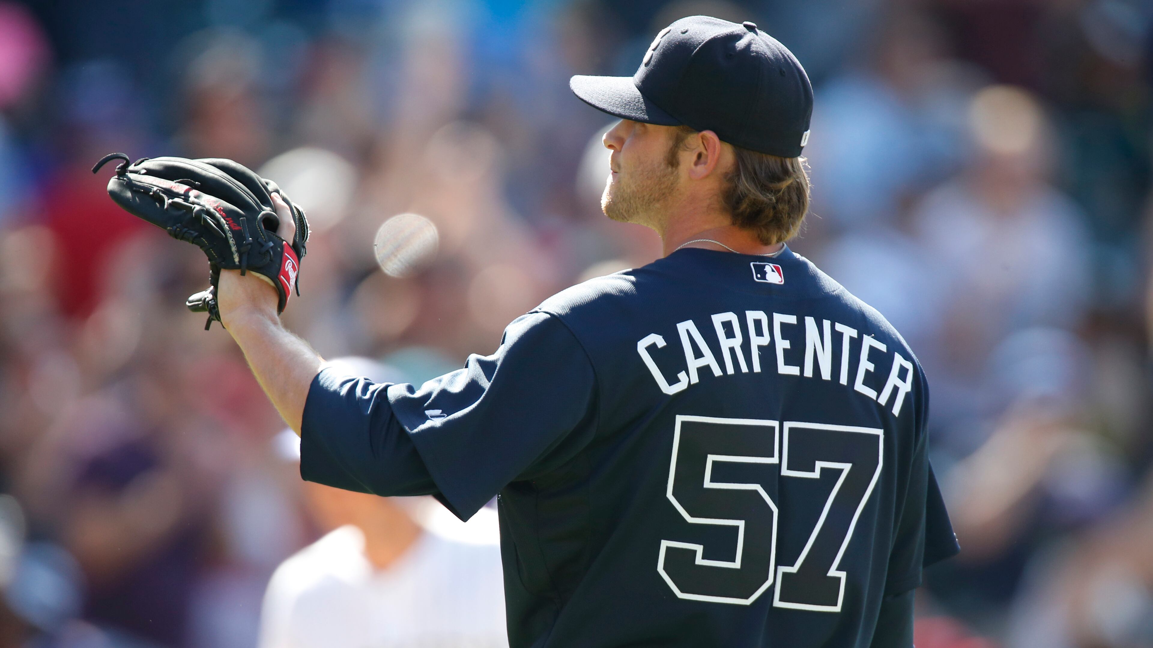 Atlanta Braves relief pitcher David Carpenter calls for a new ball after giving up a three-run home run to Colorado Rockies' Troy Tulowitzki in the bottom of the sixth inning of a baseball game, Sunday, July 12, 2015, in Denver. (AP Photo/David Zalubowski)