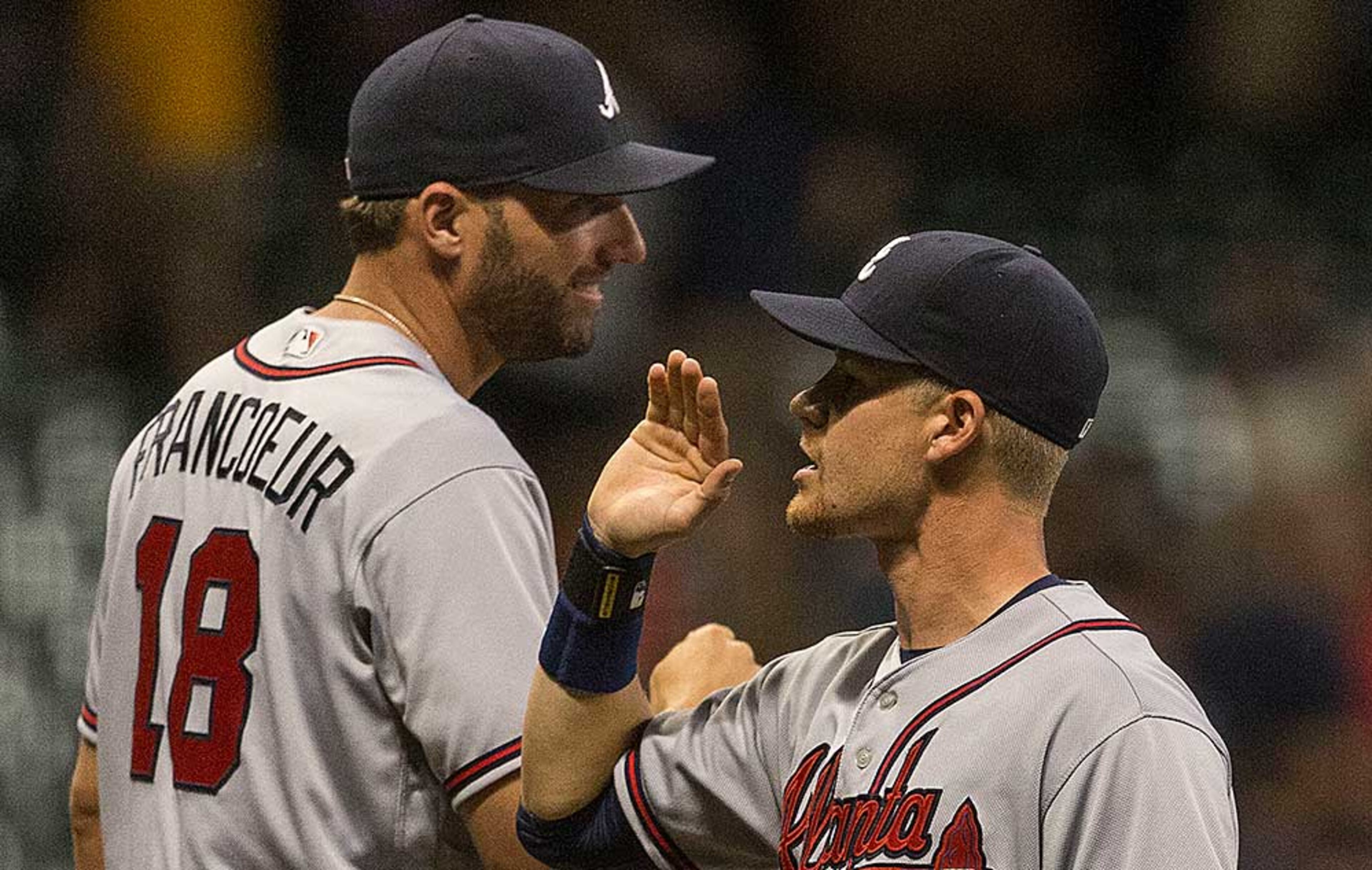 Gordon Beckham, who delivered the key sacrifice fly in the 12th, celebrates with Jeff Francoeur after the Braves' 4-3 win Monday.