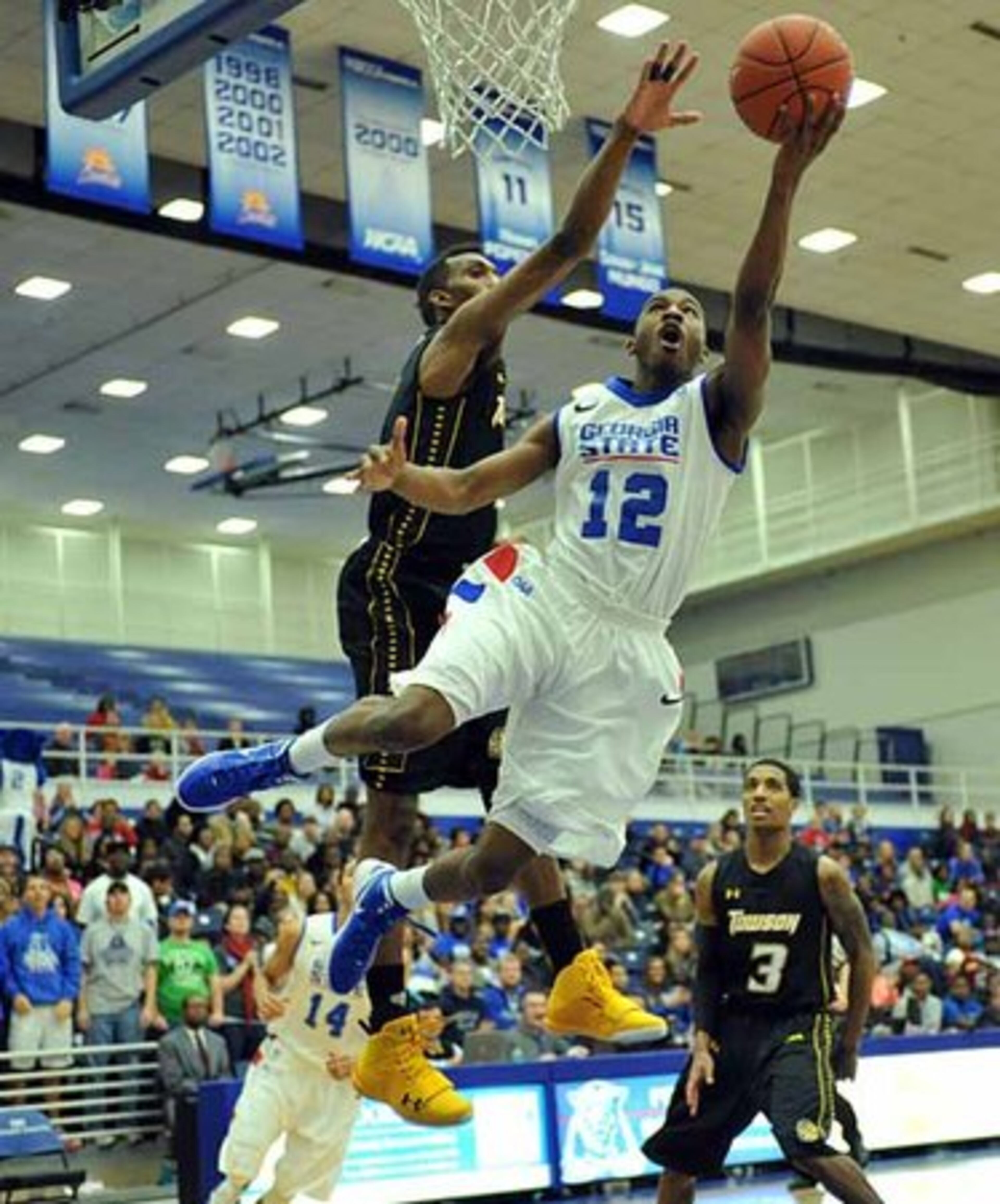 Georgia State guard Devonta White (12) goes to the basket as Towson forward Marcus Damas (1) tries to block.