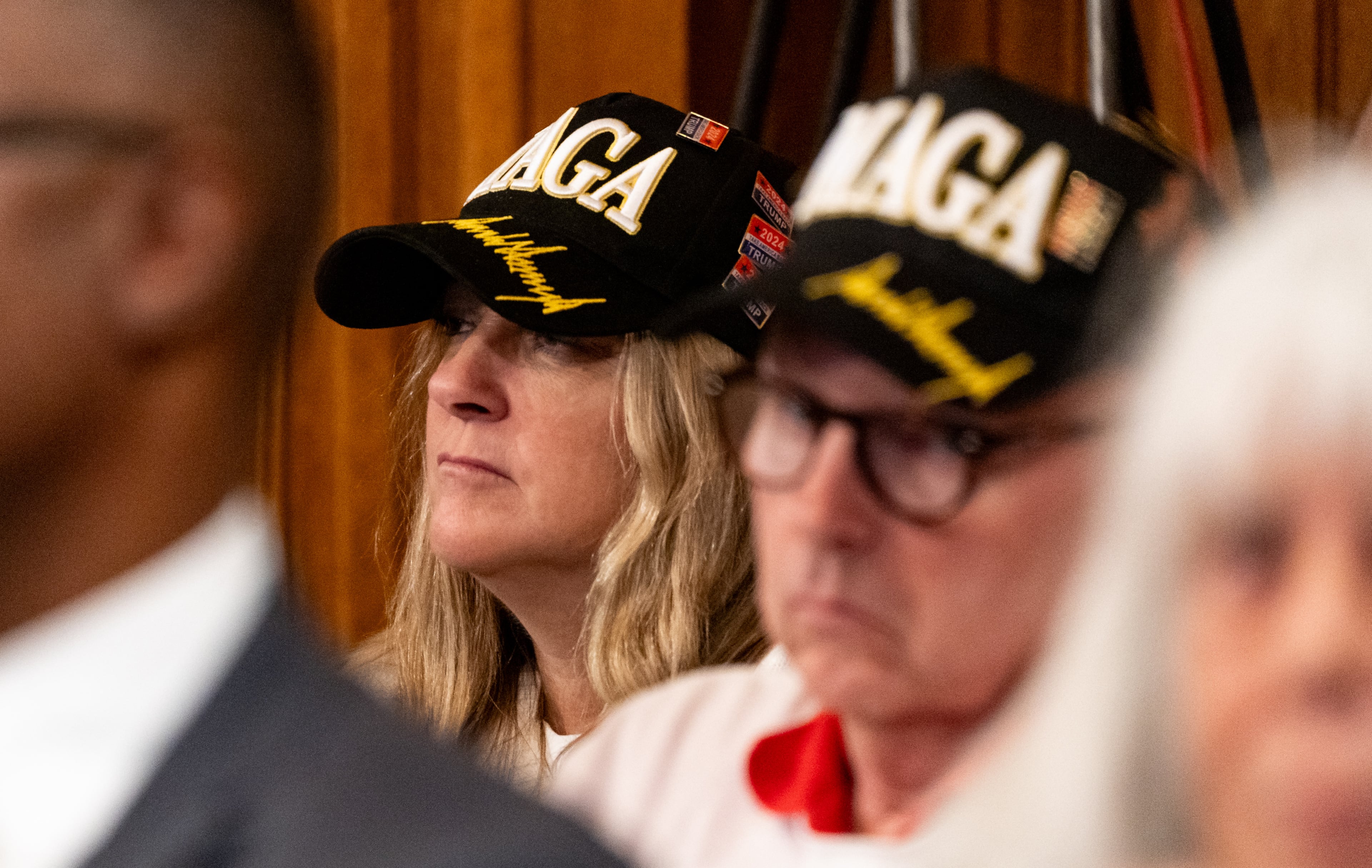 Members of the public wearing MAGA hats watch a State Election Board meeting Tuesday at the Georgia Capitol in Atlanta.