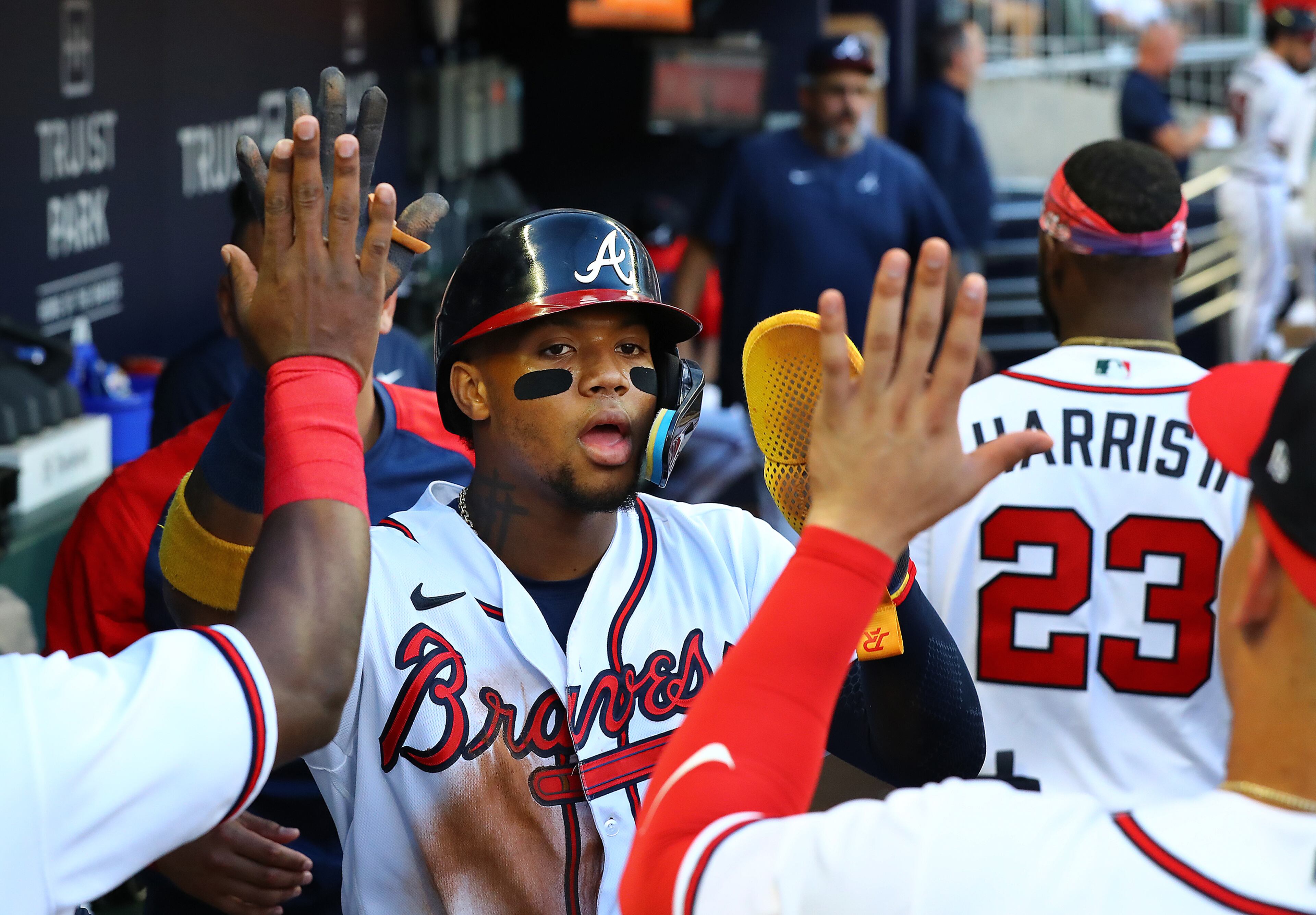 Braves outfielder Ronald Acuna celebrates with teammates after scoring on a hit by Dansby Swanson in the team's 3-1 victory over the Pirates Thursday at Truist Park. (Curtis Compton/ccompton@ajc.com)
