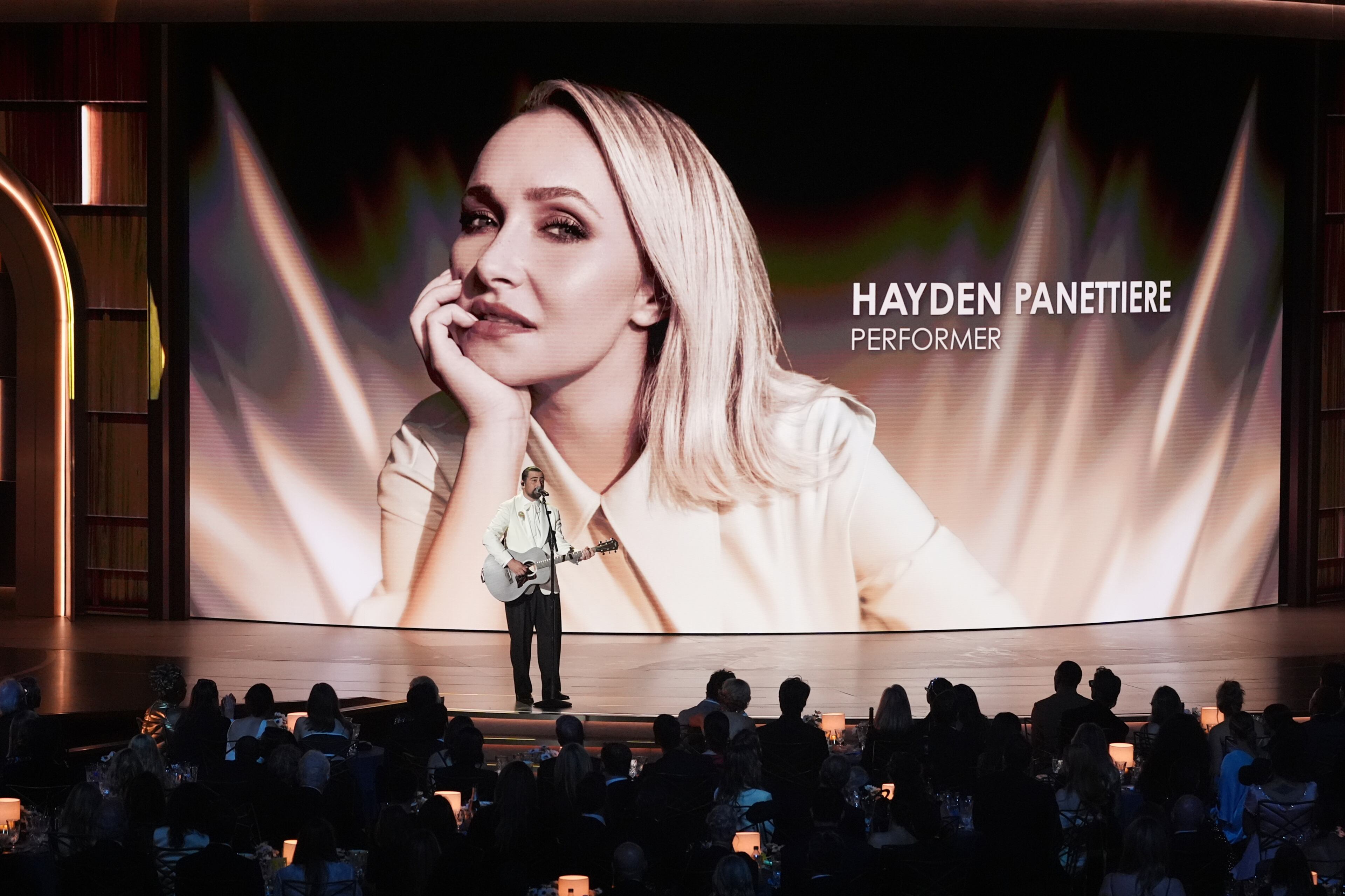 An image of Hayden Panettiere is shown while Noah Kahan performs "Bridge Over Troubled Water" during an in memoriam presentation during the 78th Emmy Awards on Monday, Sept. 14, 2026, at the Peacock Theater in Los Angeles. (Chris Pizzello/AP)