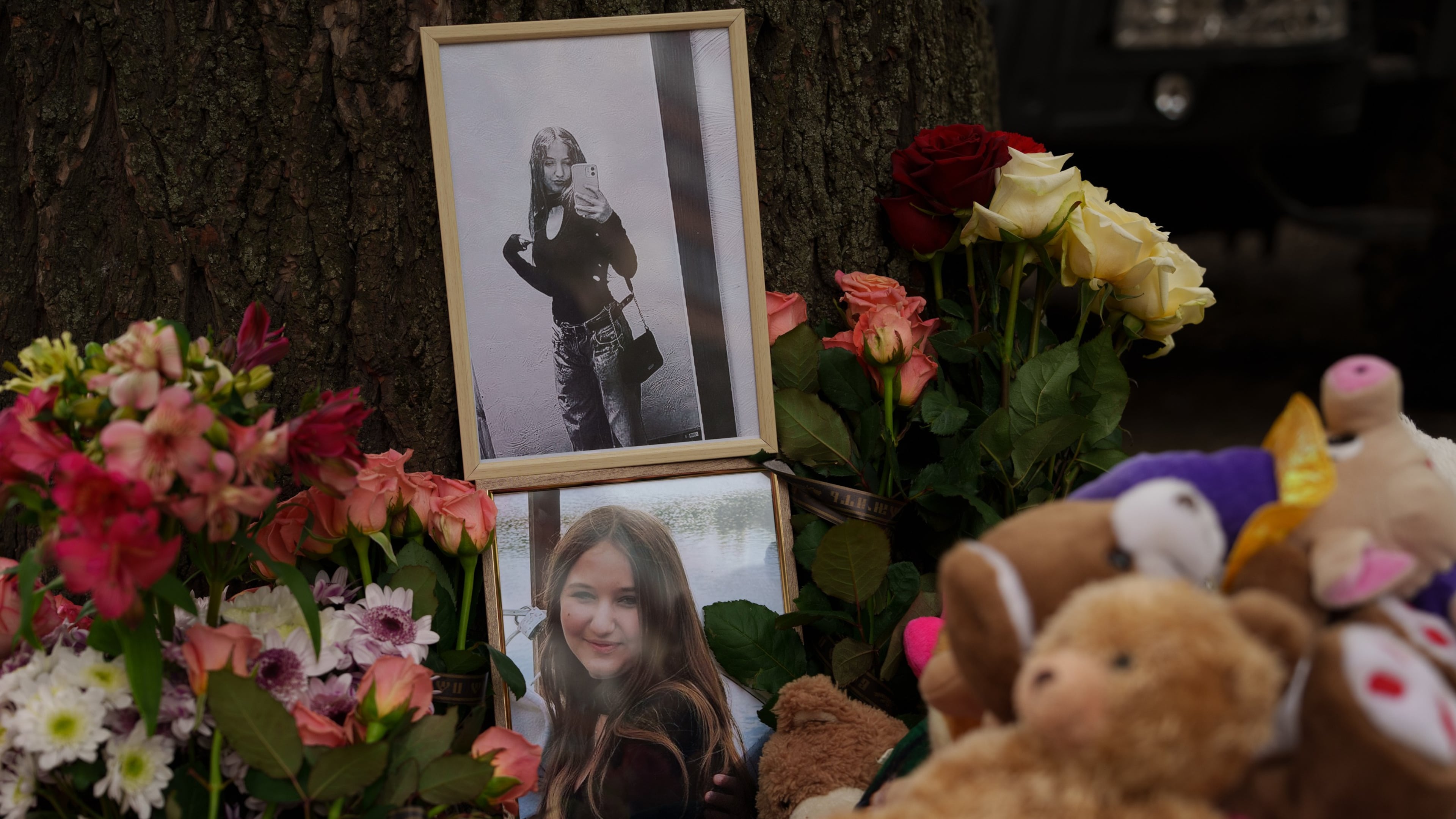 Photos of a girl who was killed are seen among flowers near a heavily damaged house after a Russian strike on a residential neighborhood in Kyiv, Ukraine, Friday, May 15, 2026. (AP Photo/Evgeniy Maloletka)