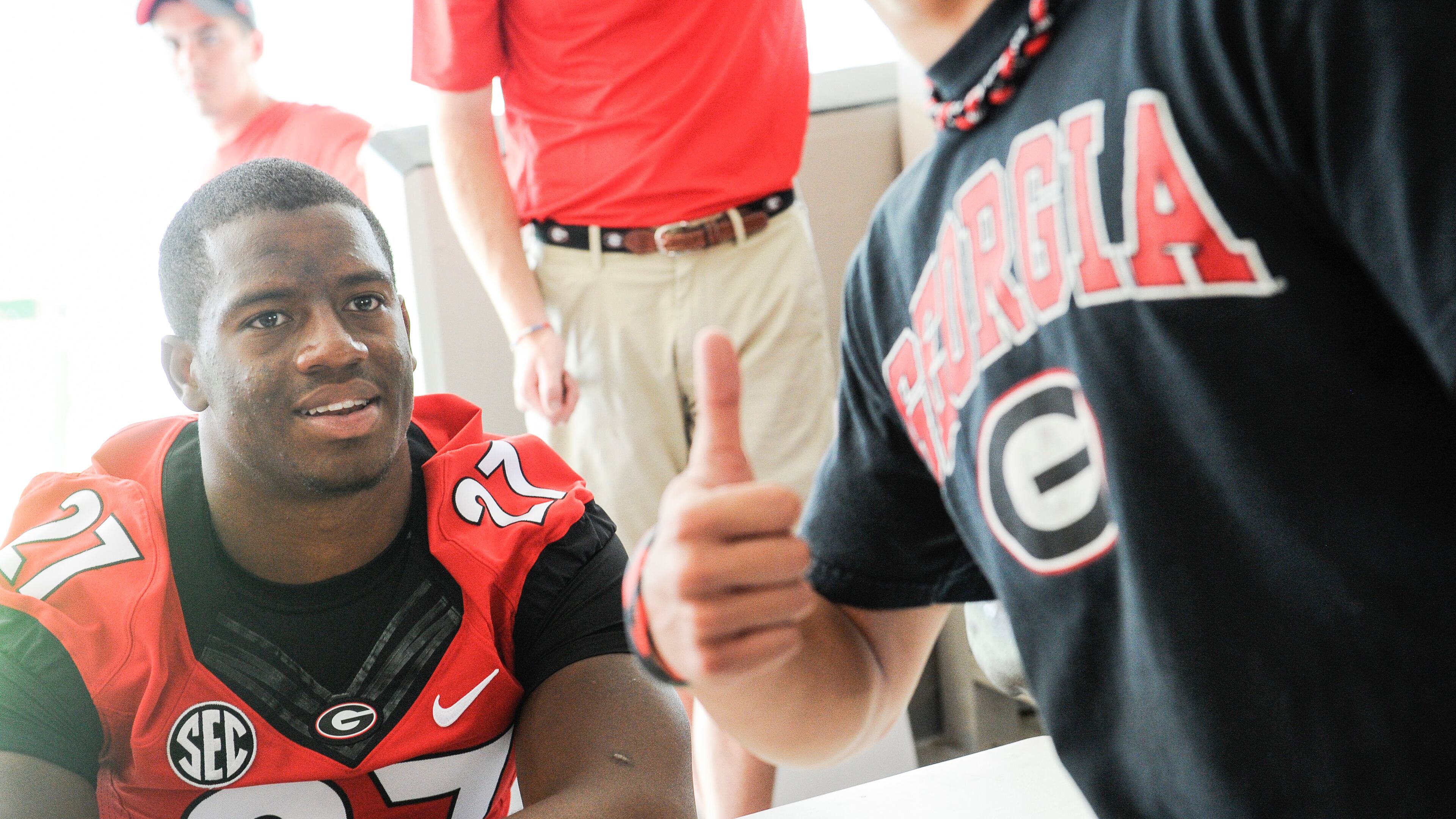 Georgia running back Nick Chubb (27) poses for a selfie with a fan during UGA Picture Day 2015.