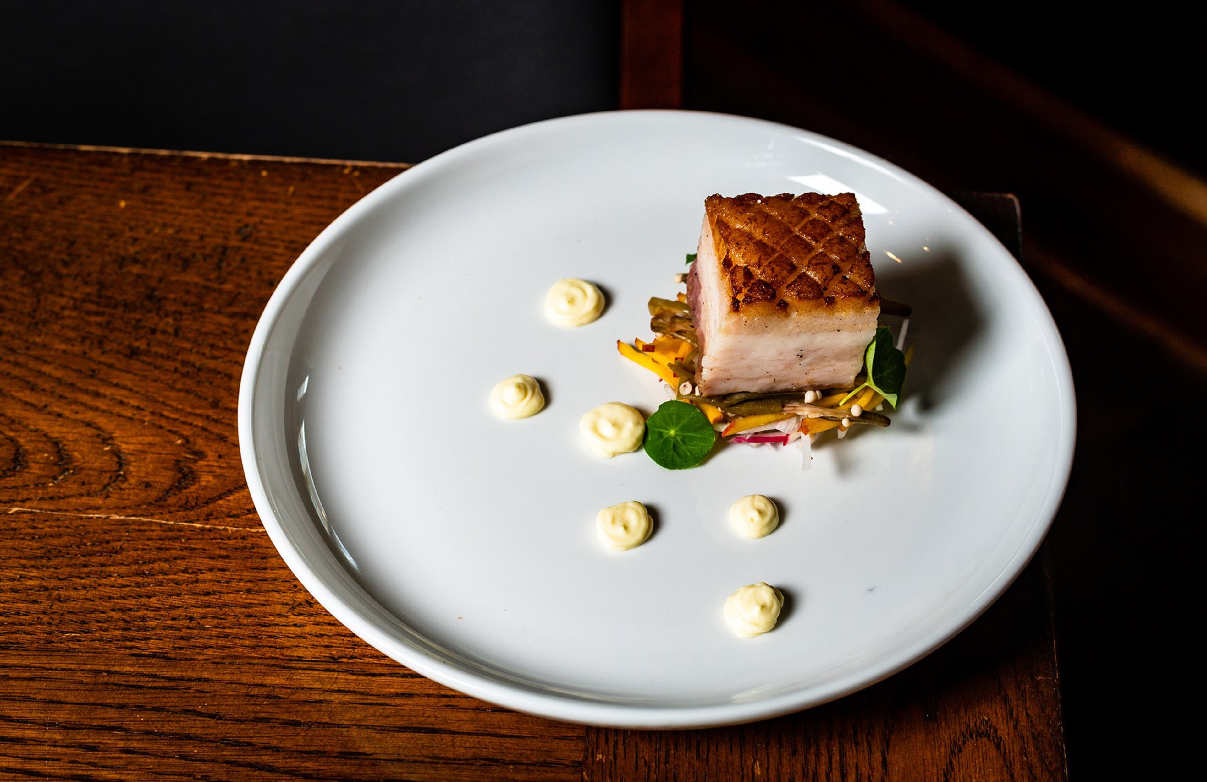 Braised Pork Belly with Pickled Okra and Fried Egg Puree from Oak Steakhouse. CONTRIBUTED BY HENRI HOLLIS