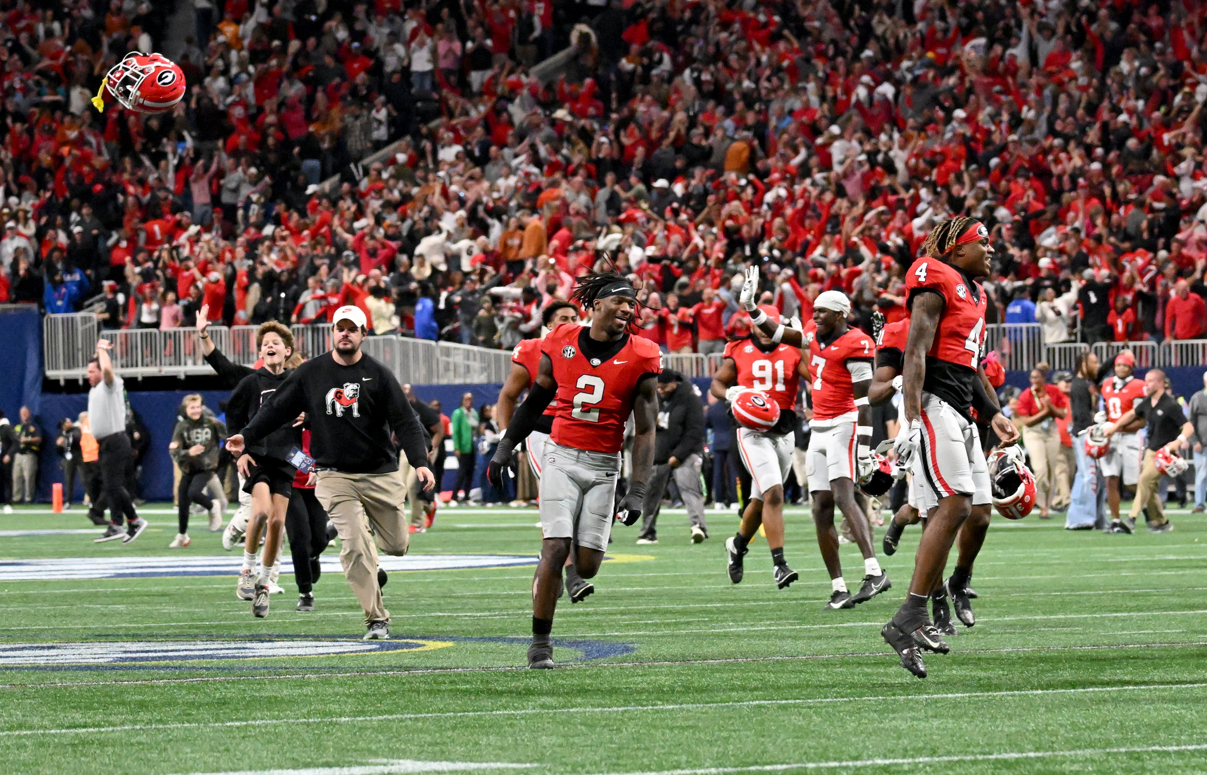 Georgia players celebrate after running back Trevor Etienne scored the game winning touchdown in overtime during the SEC Championship football game at the Mercedes-Benz Stadium, Saturday, December 7, 2024, in Atlanta. Georgia won 22-19 over Texas in overtime. (Hyosub Shin / AJC)