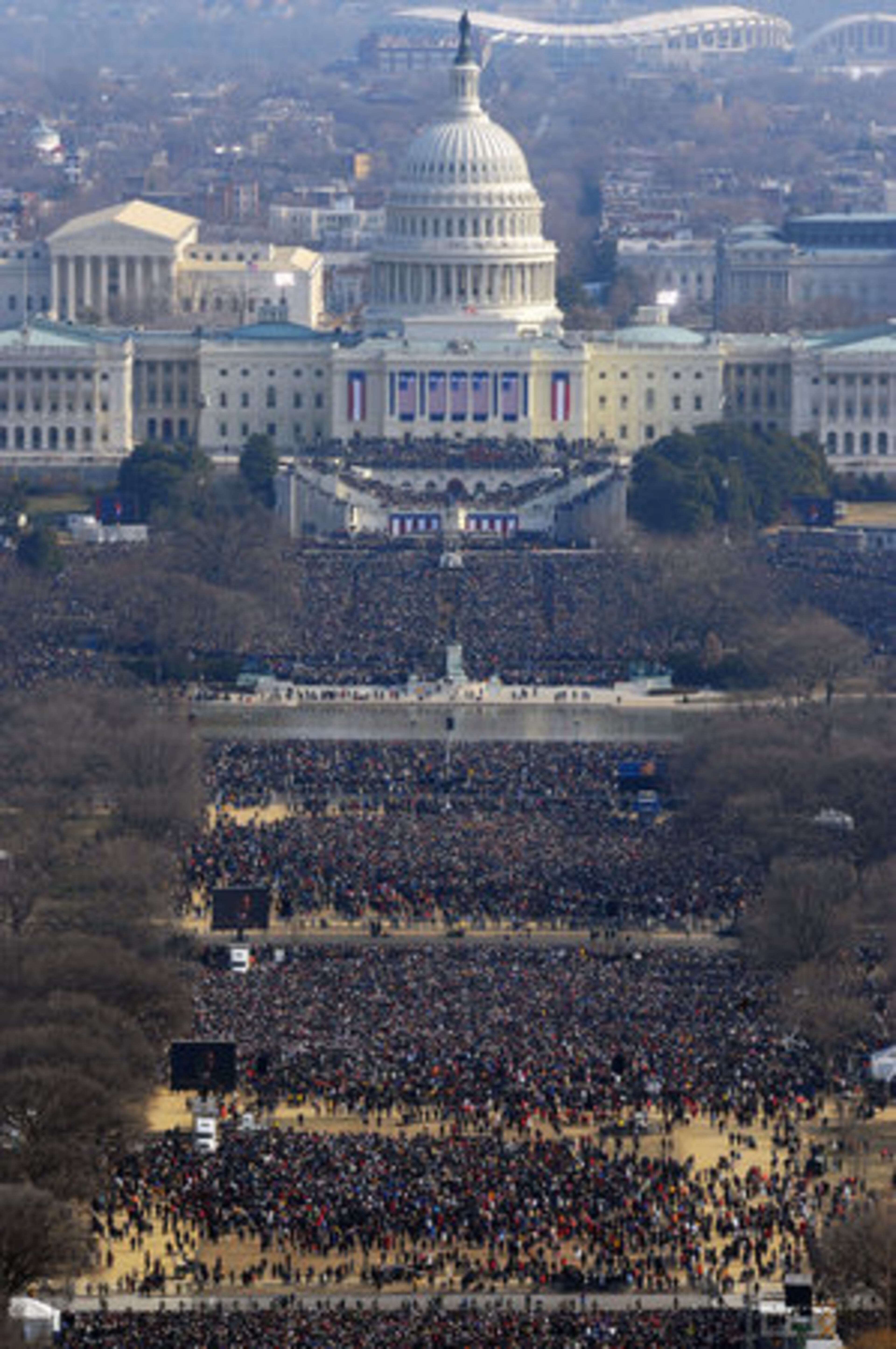 People fill the Mall to watch President Barack Obama on large screens after he was sworn in as the 44th US president by Supreme Court Chief Justice John Roberts in front of the Capitol in Washington. Some two million people erupted in joyous celebration, cheering and waving a sea of flags as Obama took the oath of office.