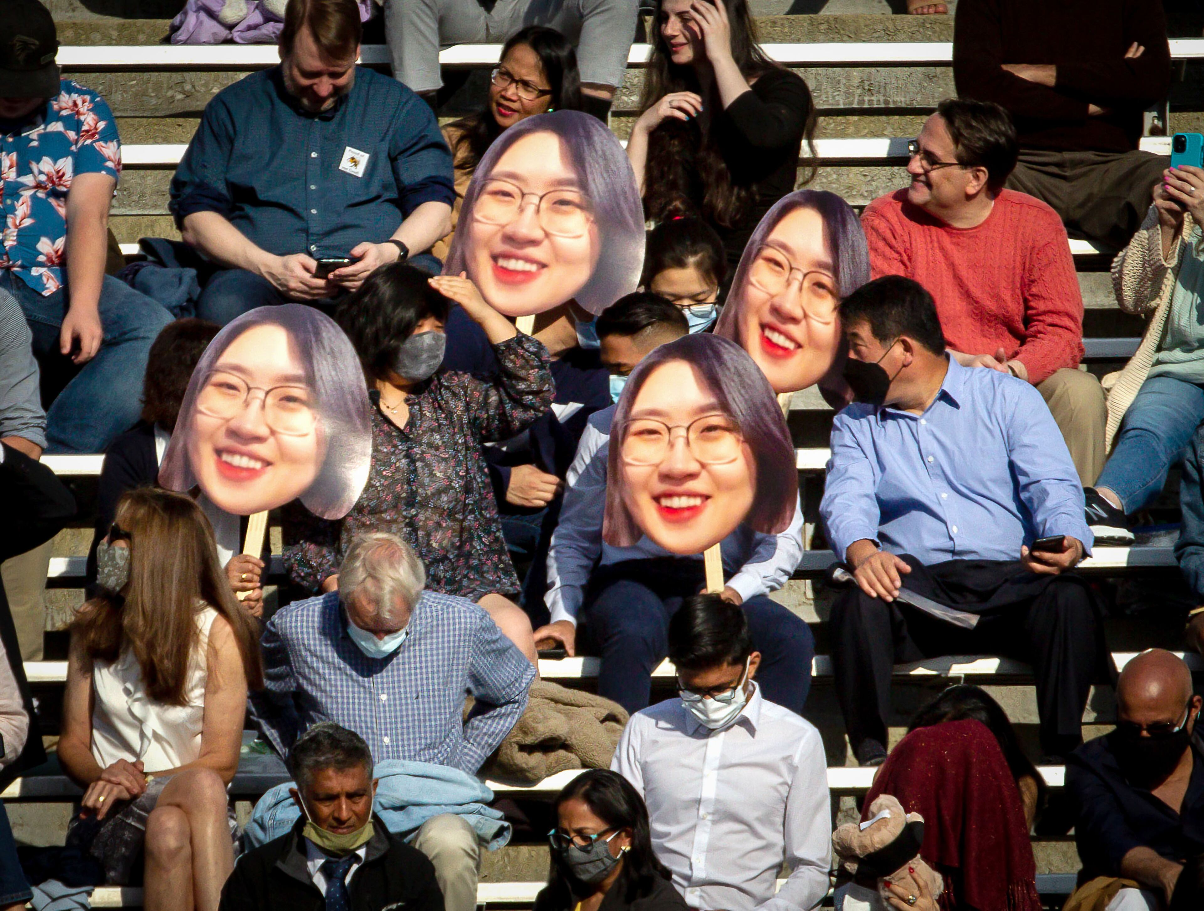 People in the stands hold up large face photos during the Georgia Tech 2021 commencement ceremony in Bobby Dodd Stadium on Saturday, May 8, 2021. Two ceremonies were held Saturday for bachelor’s degree recipients, and master's and doctoral graduates' ceremonies were held Friday. (Photo: Steve Schaefer for The Atlanta Journal-Constitution)