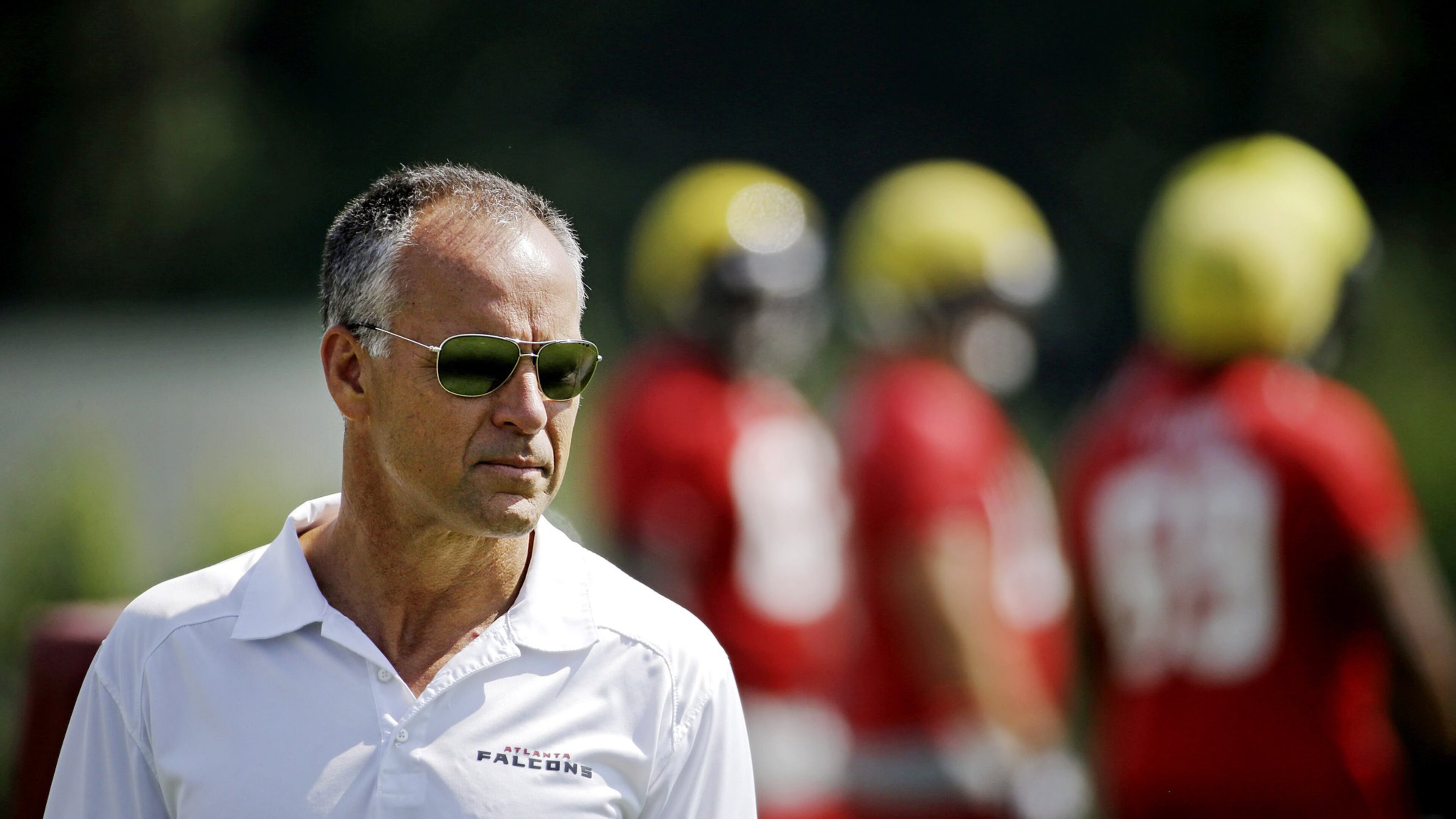 FILE - In this June 4, 2014, file photo, Atlanta Falcons defensive coordinator Mike Nolan watches during NFL football practice in Flowery Branch, Ga. Nolan’s third season as Falcons defensive coordinator, and 17th overall, hasn’t been easy. Atlanta is ranked last against the pass as it prepares for its hardest test of the season with a trip to Green Bay against quarterback Aaron Rodgers. (AP Photo/David Goldman, File)