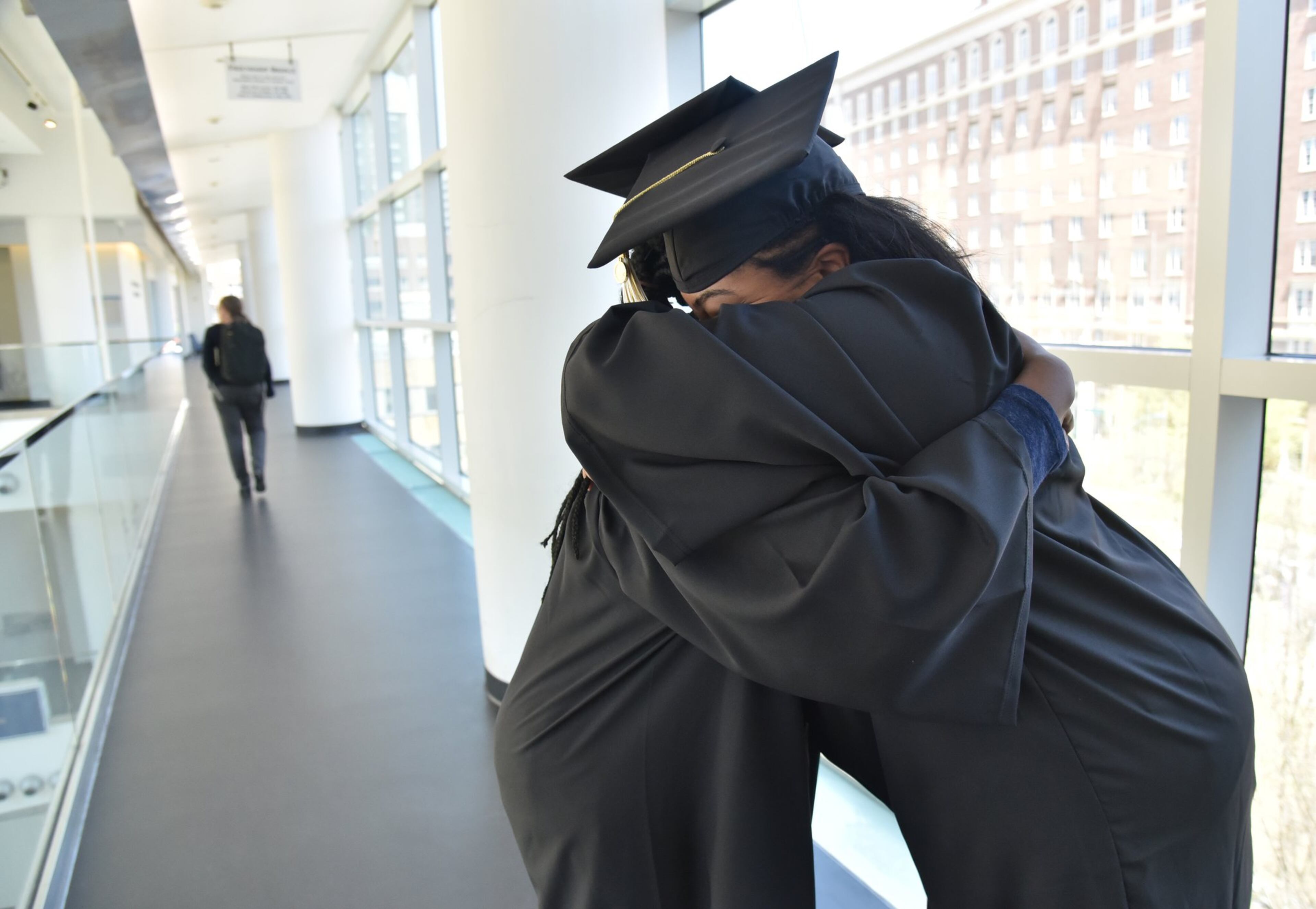 Carrie Crayton and Natalie Jackson (right), both first graduating class of EXCEL program for students with mild intellectual and developmental disabilities, embrace after they try on their caps and gowns at Georgia Tech’s Scheller College of Business.