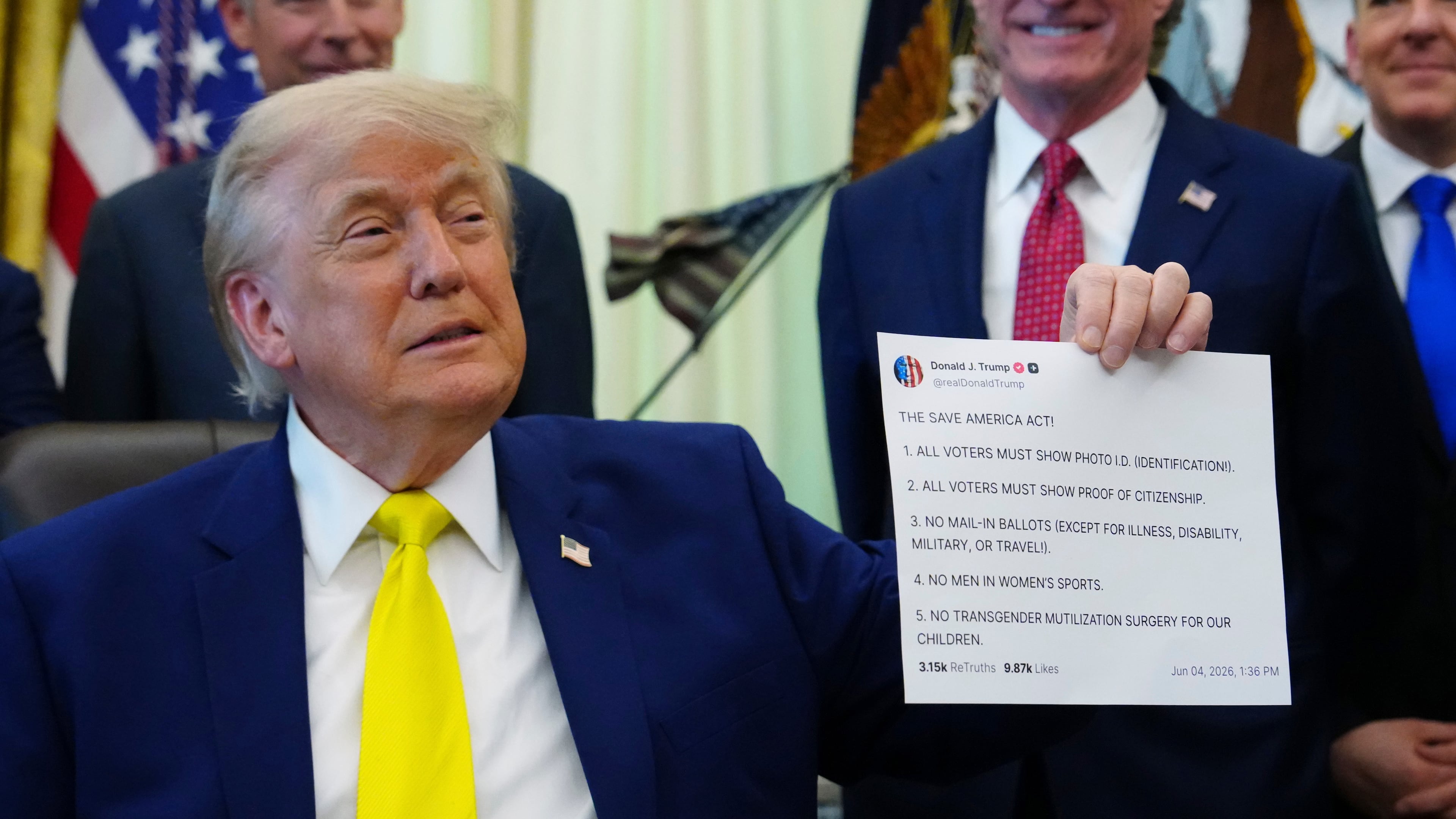 FILE - President Donald Trump holds up an image taken from his Truth Social account at an event about coal, Thursday, June 4, 2026, in the Oval Office of the White House in Washington. (AP Photo/Julia Demaree Nikhinson,File)