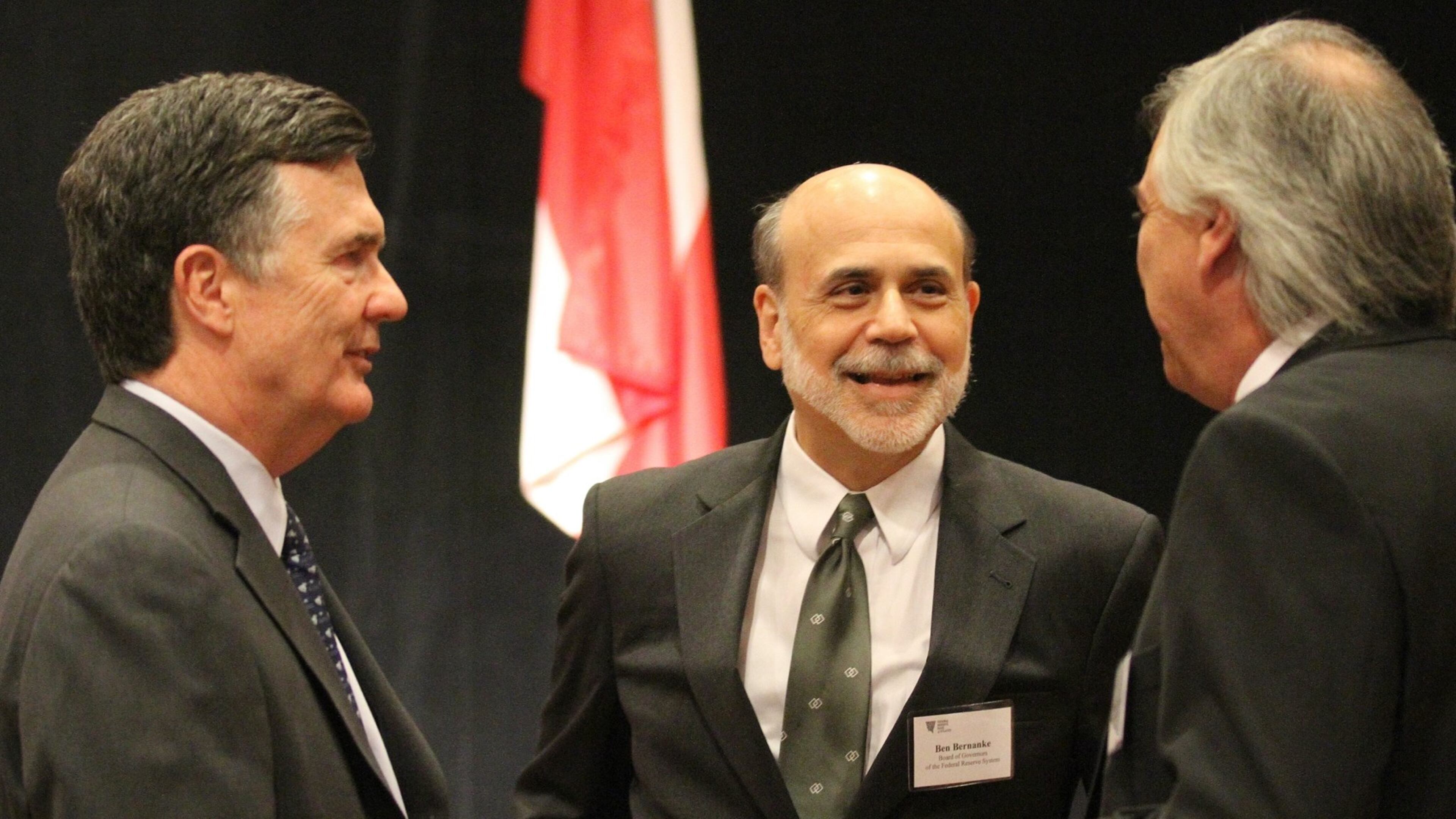 Dennis Lockhart (left), President and CEO of the Federal Reserve Bank of Atlanta, speaks with then-Federal Reserve Chairman Ben Bernanke (center) at a meeting in 2012. HYOSUB SHIN / HSHIN@AJC.COM