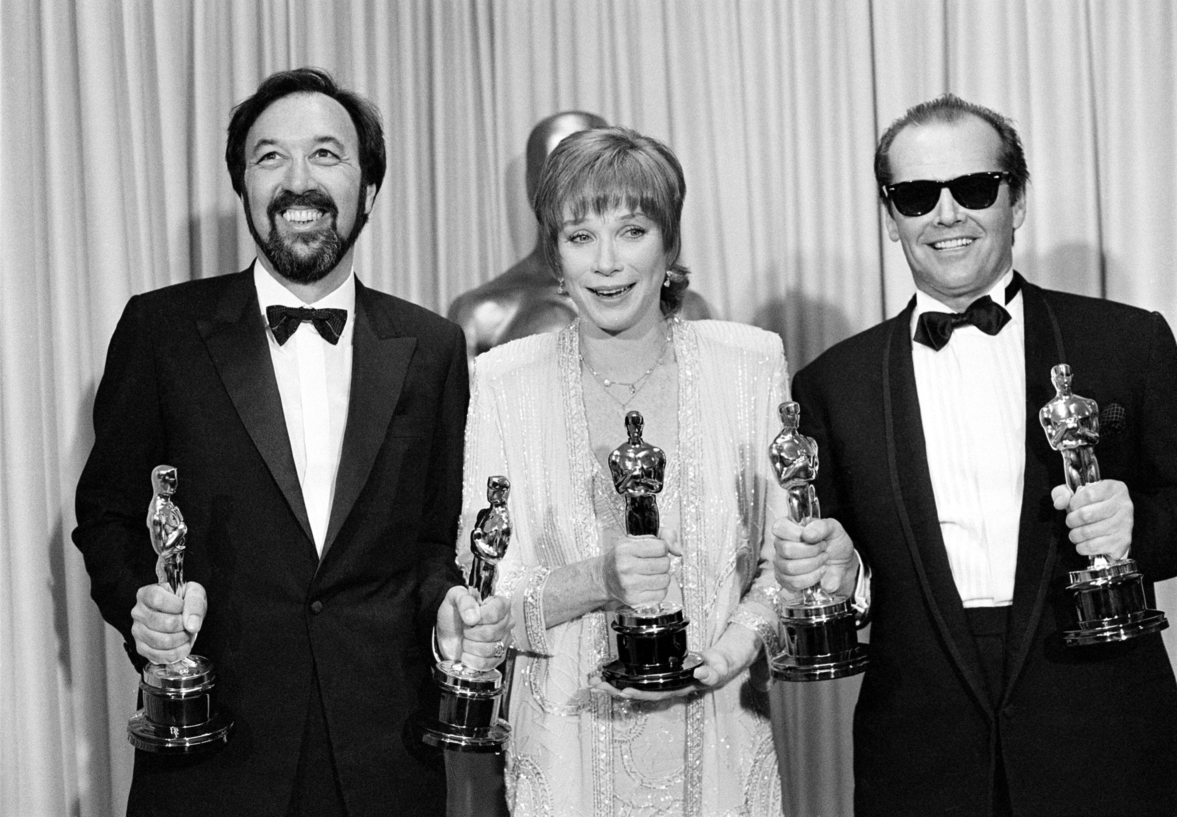 Actress Shirley MacLaine is flanked by director James L. Brooks, left, and her co-star Jack Nicholson, right, as they pose with the five Oscars they won for the motion picture "Terms of Endearment," in Los Angeles, Calif., on April 9, 1984.