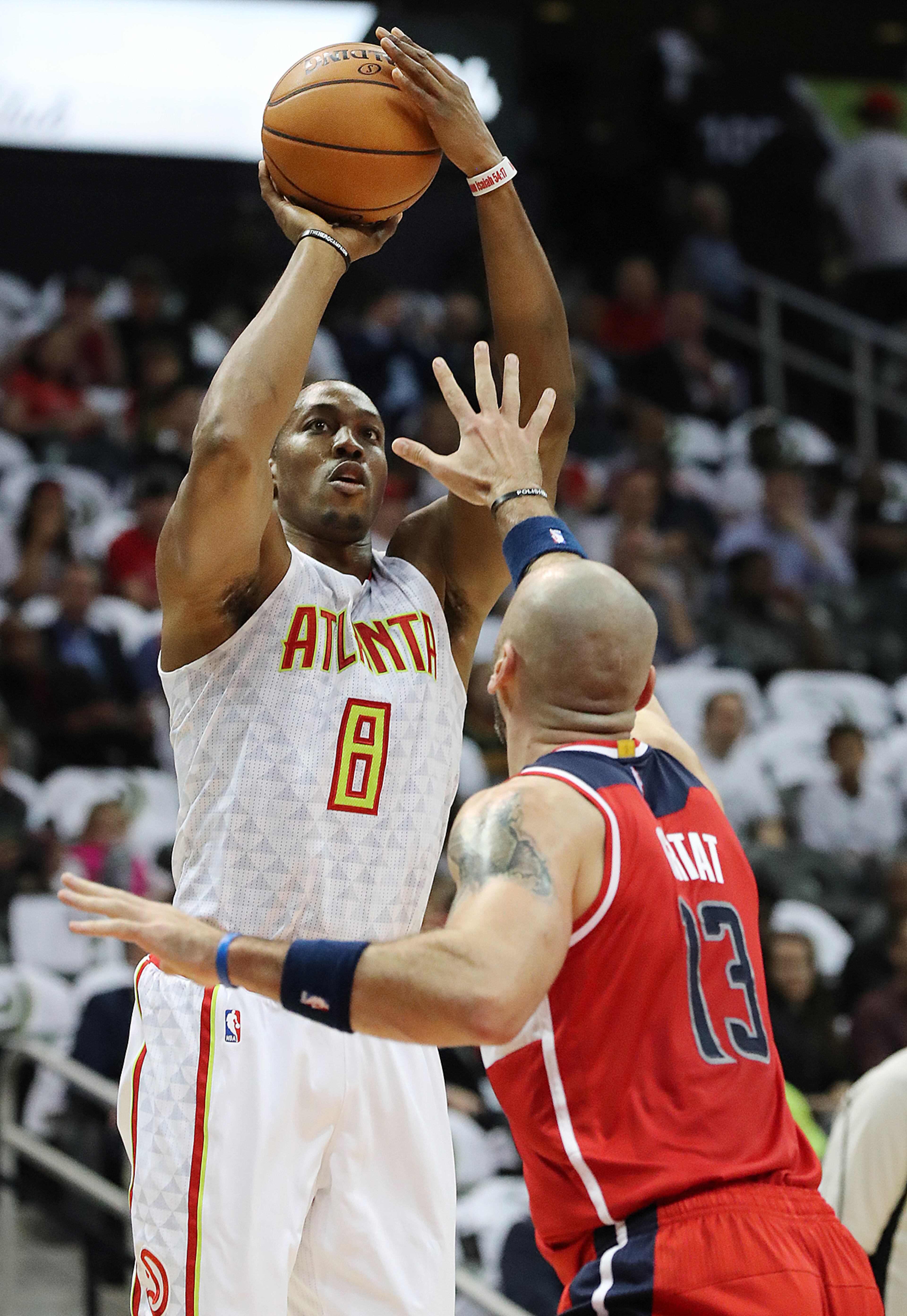 Hawks Dwight Howard shoots for two points over Wizards Marcin Gortat during the first period in the home opener of their NBA basketball game at Philips Arena on Thursday, Oct. 27, 2016, in Atlanta. Curtis Compton /ccompton@ajc.com