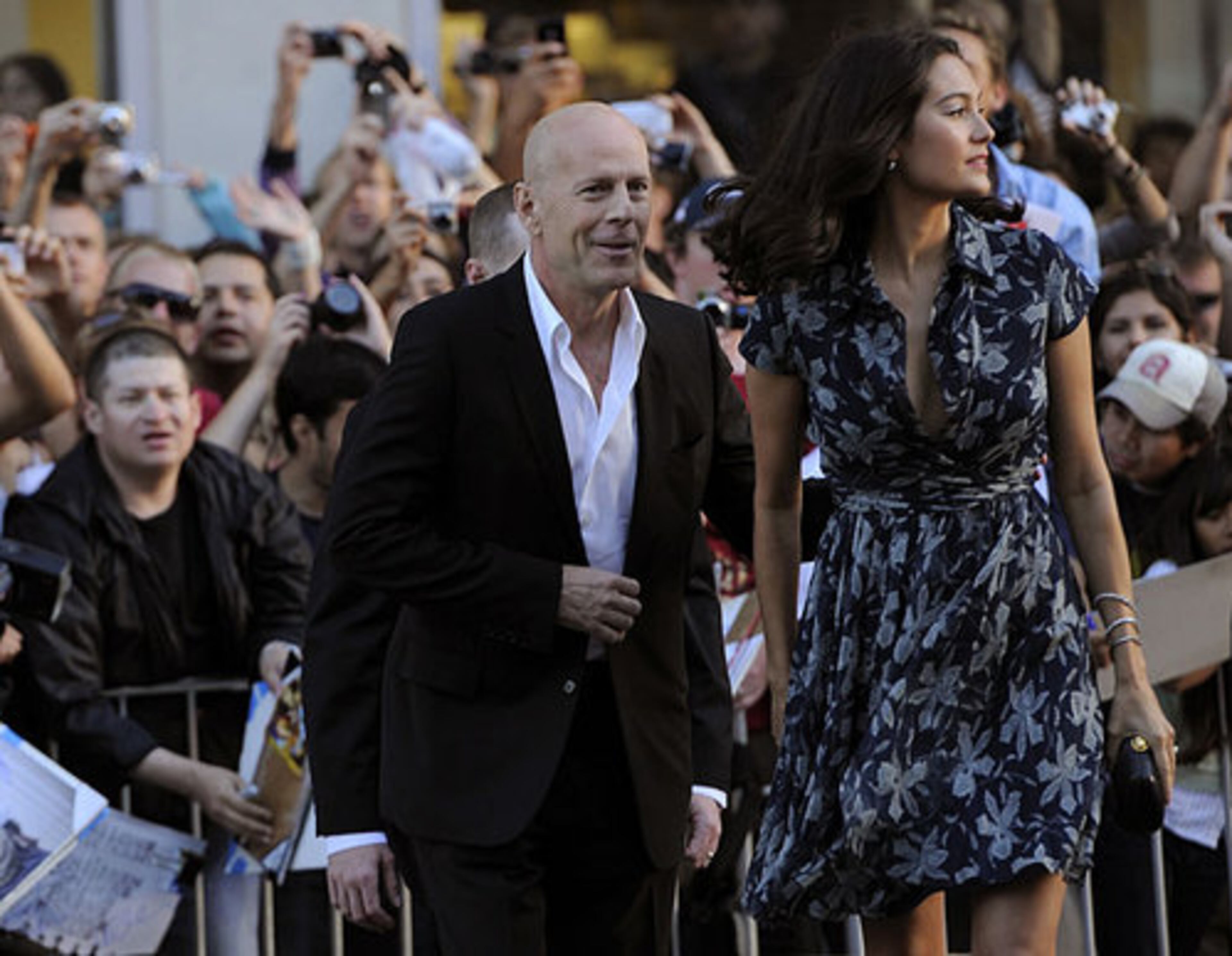 Bruce Willis, a cast member in "The Expendables, " arrives with his wife Emma Heming at the premiere of the film in Los Angeles, Tuesday, Aug. 3, 2010.
