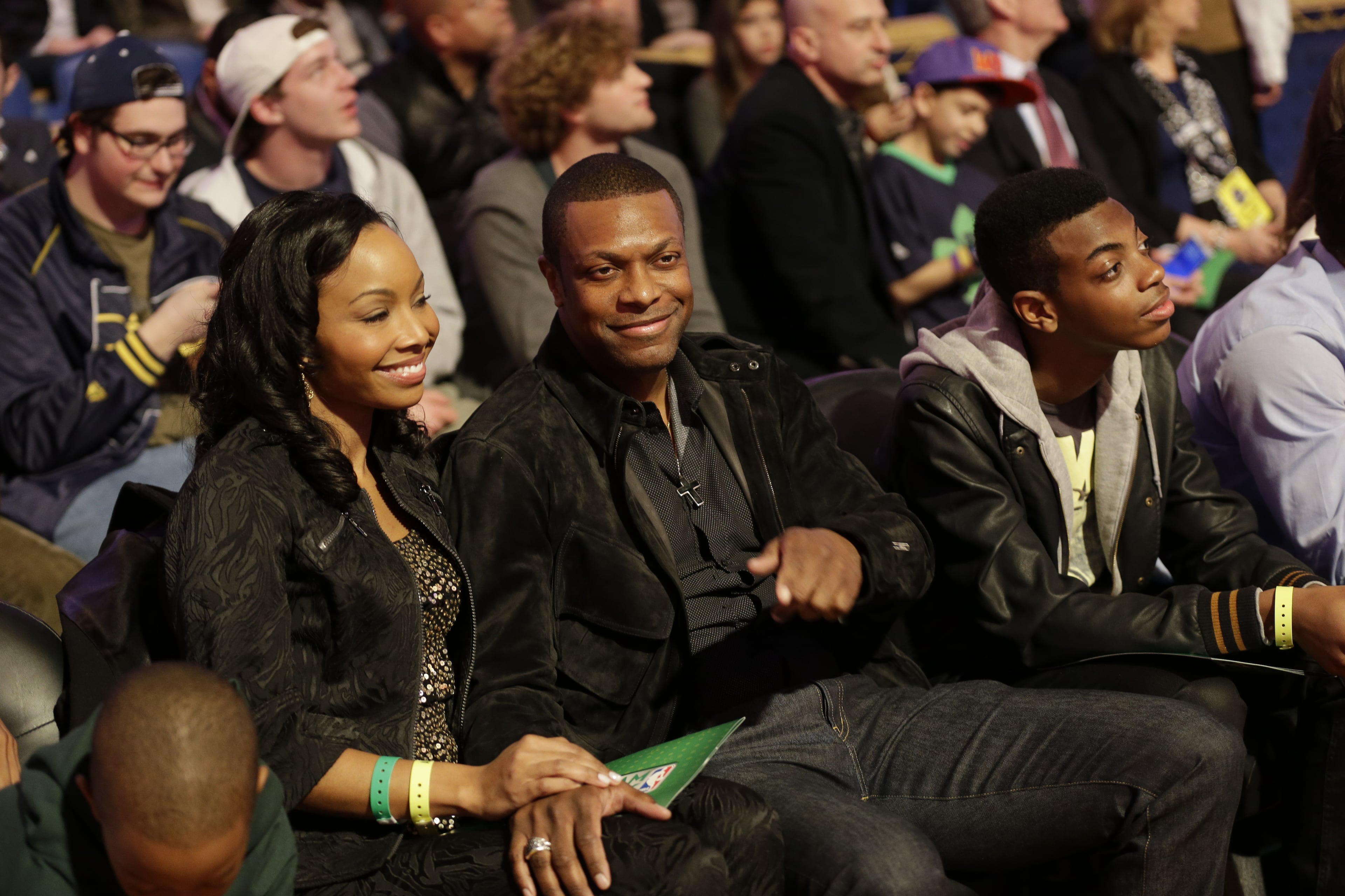 Actor Chris Tucker, center, watches play during the skills competition at the NBA All Star basketball game, Saturday, Feb. 15, 2014, in New Orleans. (AP Photo/Gerald Herbert)