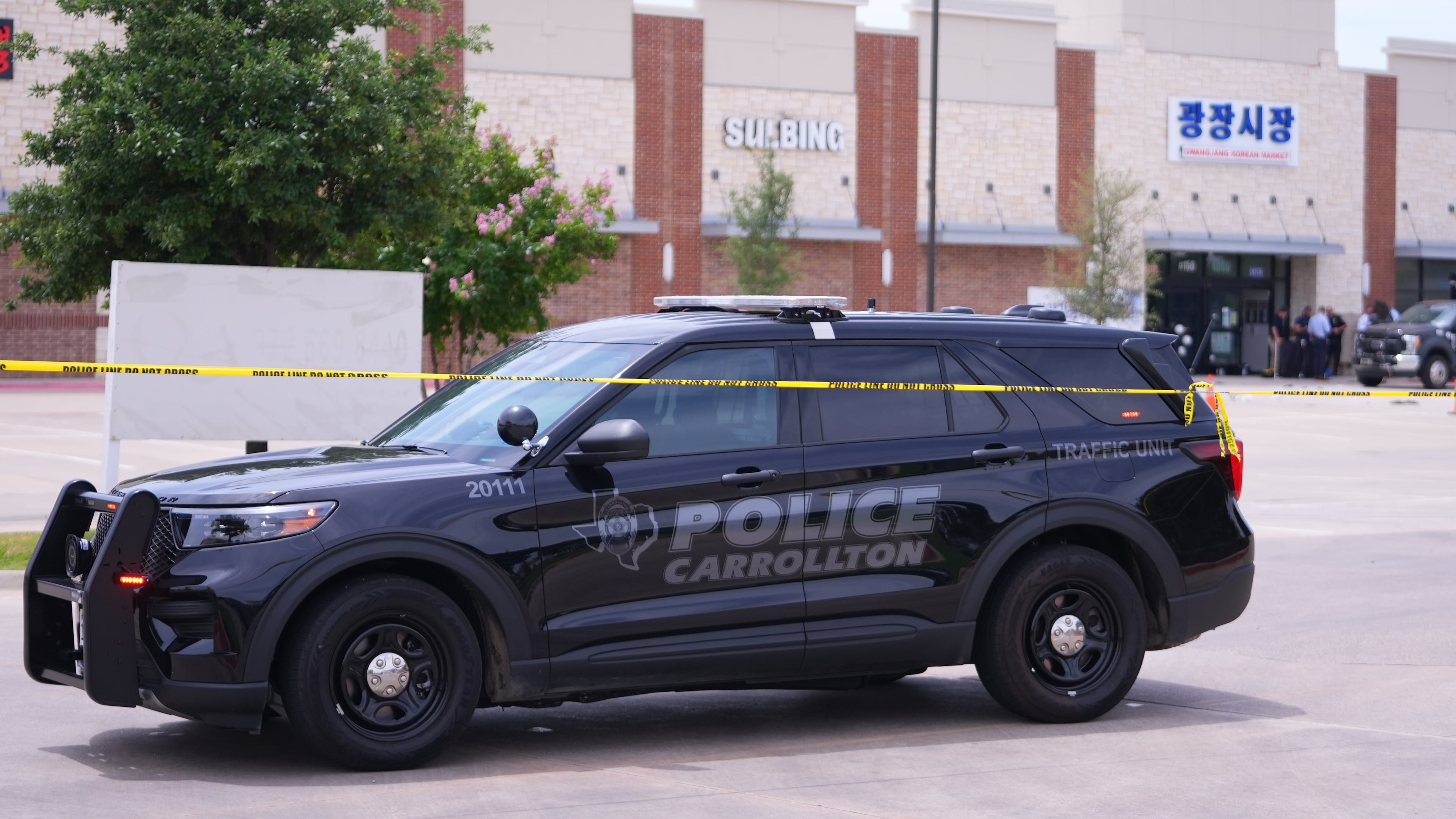 Officials respond to the scene of a shooting Tuesday, May 5, 2026, at K Towne Plaza in Carrollton, Texas. (AP Photo/Julio Cortez)