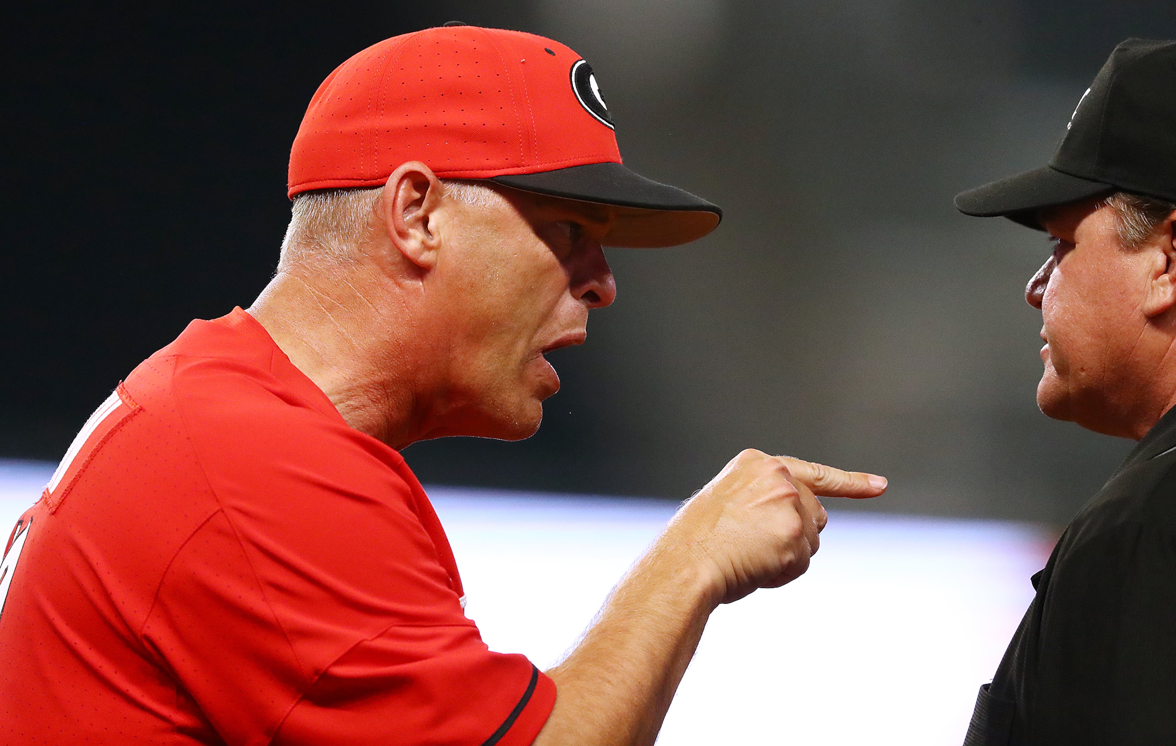 April 23, 2019 Atlanta: Georgia head coach Scott Stricklin argues a call with the first base umpire on a close call at first during the 8th inning against Georgia Tech in the Spring Classic NCAA college baseball game at SunTrust Park on Tuesday, April 23, 2019, in Atlanta. Curtis Compton/ccompton@ajc.com