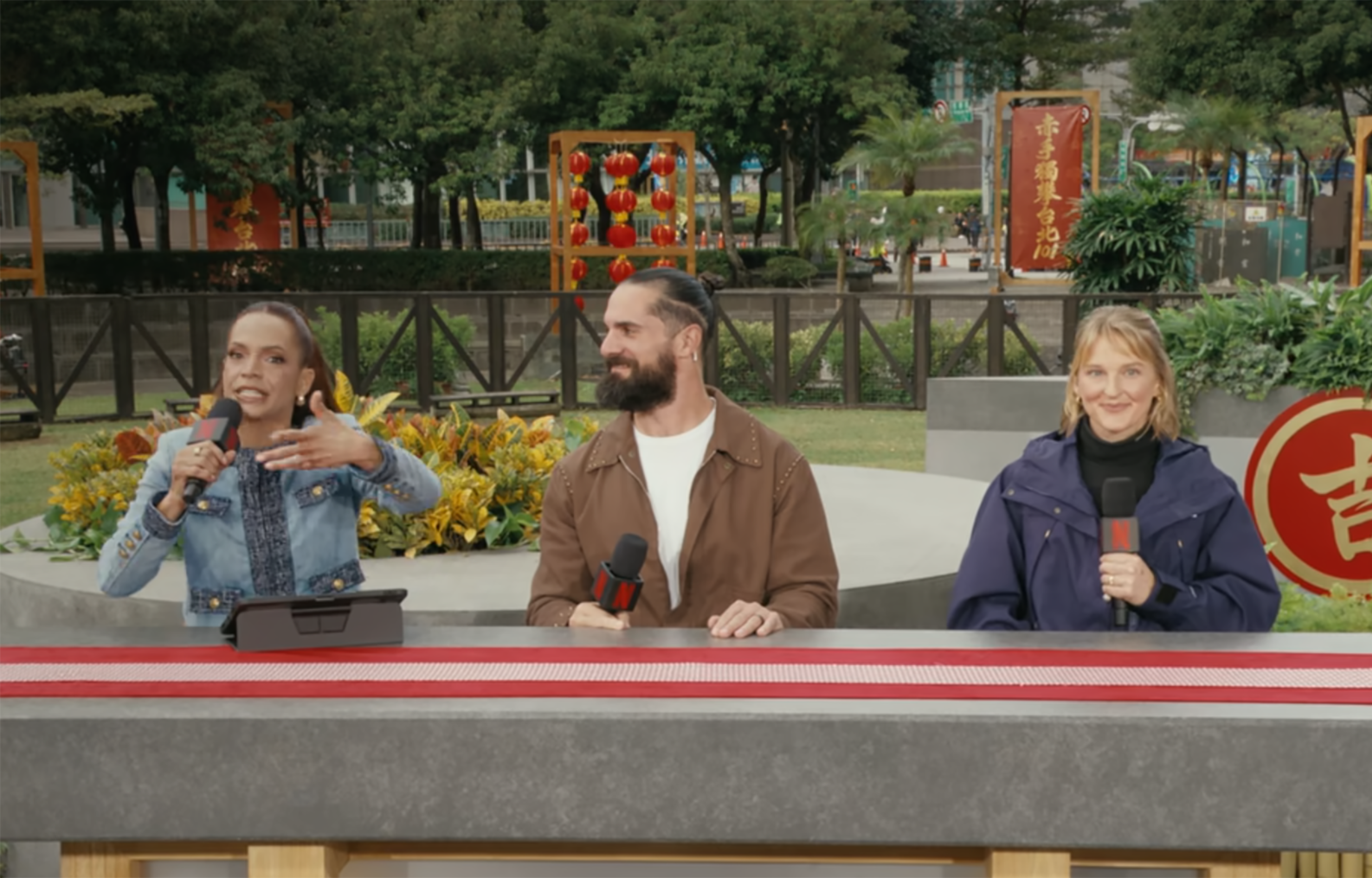 "Skyscraper Live" was Elle Duncan's (left) first hosting job for Netflix, on Jan. 24, 2026. She is joined by professional wrestler Seth Rollins (center) and professional climber Emily Harrington. (Netflix screenshot)
