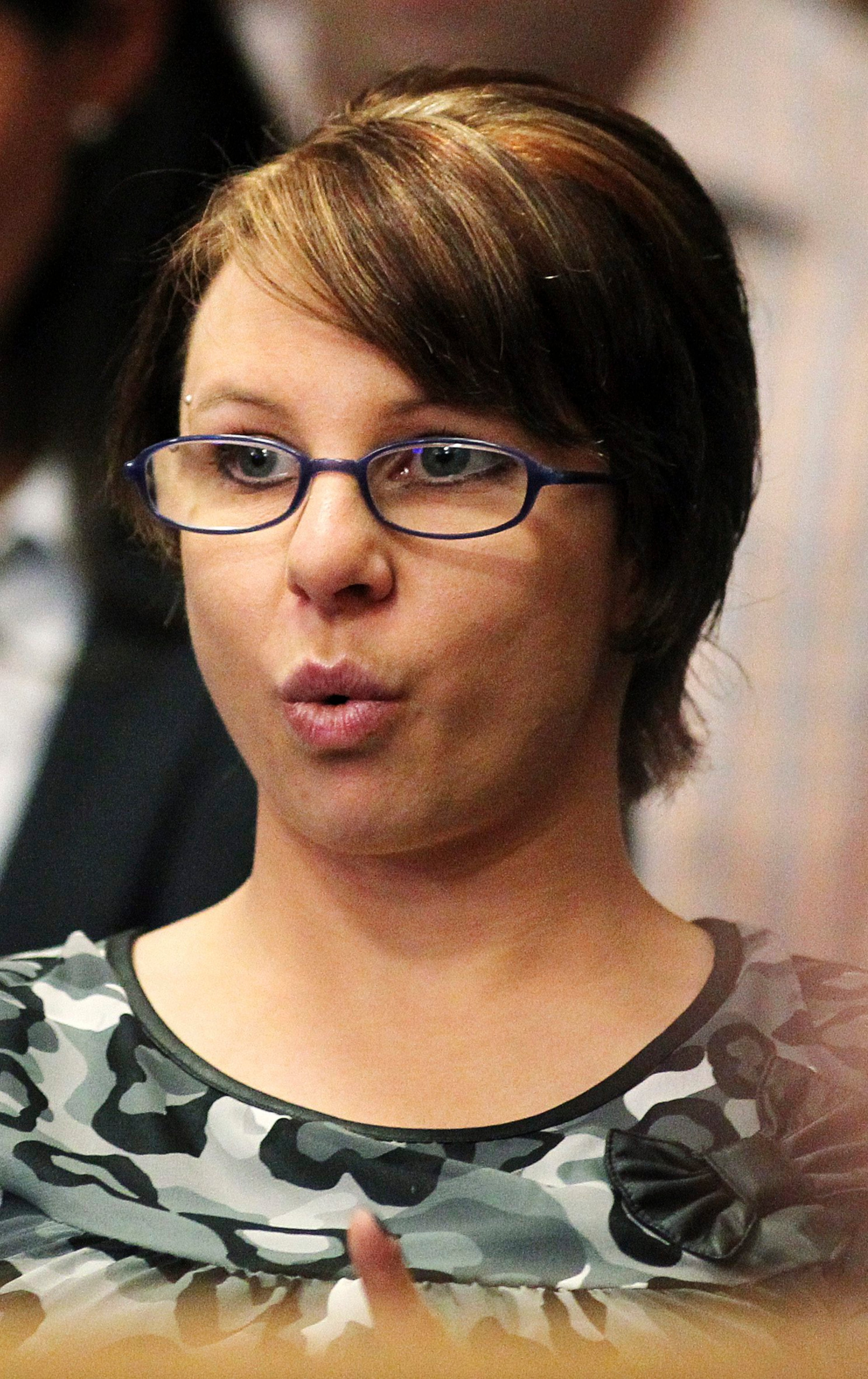 Michele Knight, one of the three kidnapped women, reacts as she attends the sentencing of accused kidnapper Ariel Castro at a court hearing in Cleveland, Ohio August 1, 2013. Witnesses testified in graphic terms on Thursday how Castro abducted three women and imprisoned them for a decade in his home, where he sometimes kept them in chains, isolated from each other and without regular meals. REUTERS/Aaron Josefczyk (UNITED STATES - Tags: CRIME LAW HEADSHOT)