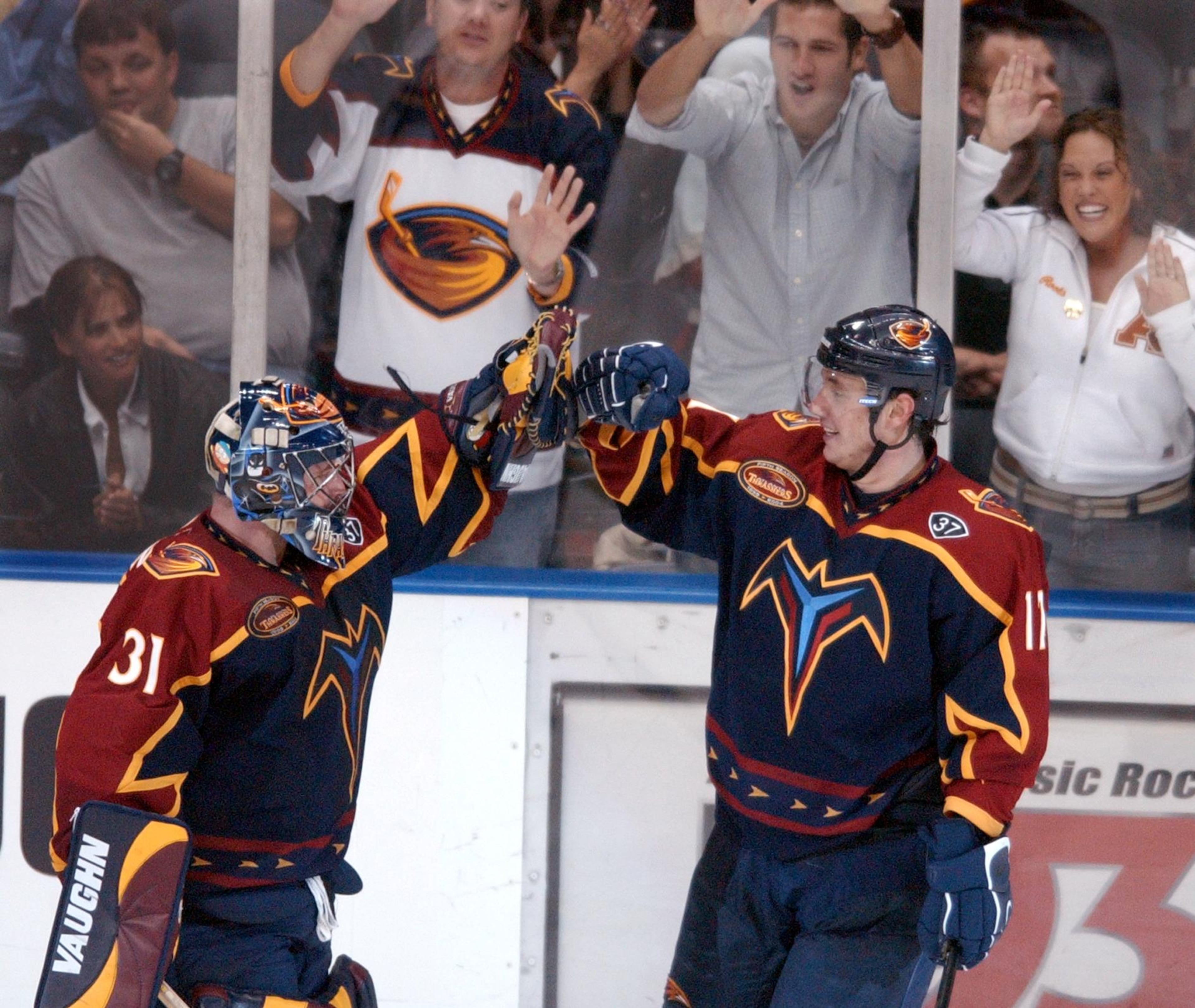 Thrashers left wing IIya Kovalchuk, right, celebrates his 3rd goal of the game for the hat trick with teammate goaltender Pasi Nurminen, left, to give the Thrashers a 4-0 victory in 3rd period action against the Predators in Atlanta on Thursday, Oct. 23, 2003. (CURTIS COMPTON/staff)