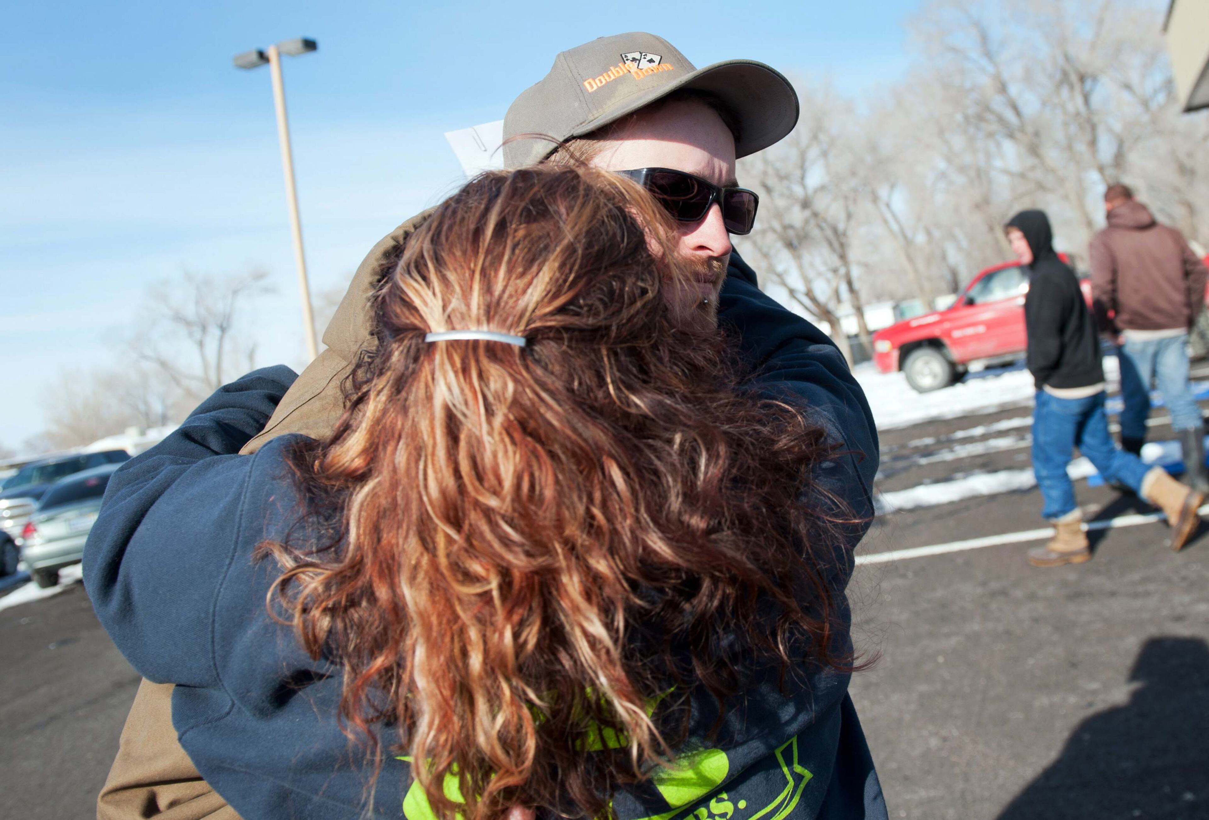 Ernie Carmichael, of Lovelock, hugs Chris Montes (R) after hearing that Montes was one of the rescuers that found a family in a remote mountain range northeast of Reno, in Lovelock, Nevada, December 10, 2013. A Nevada couple and four young children reported missing on Sunday were found safe by rescue workers on Tuesday huddled in a canyon, a dispatch supervisor for the Pershing County Sheriff's Office said. Montes said the group was stranded after their truck rolled over but that they were doing well and were in good spirits when he found them. REUTERS/James Glover