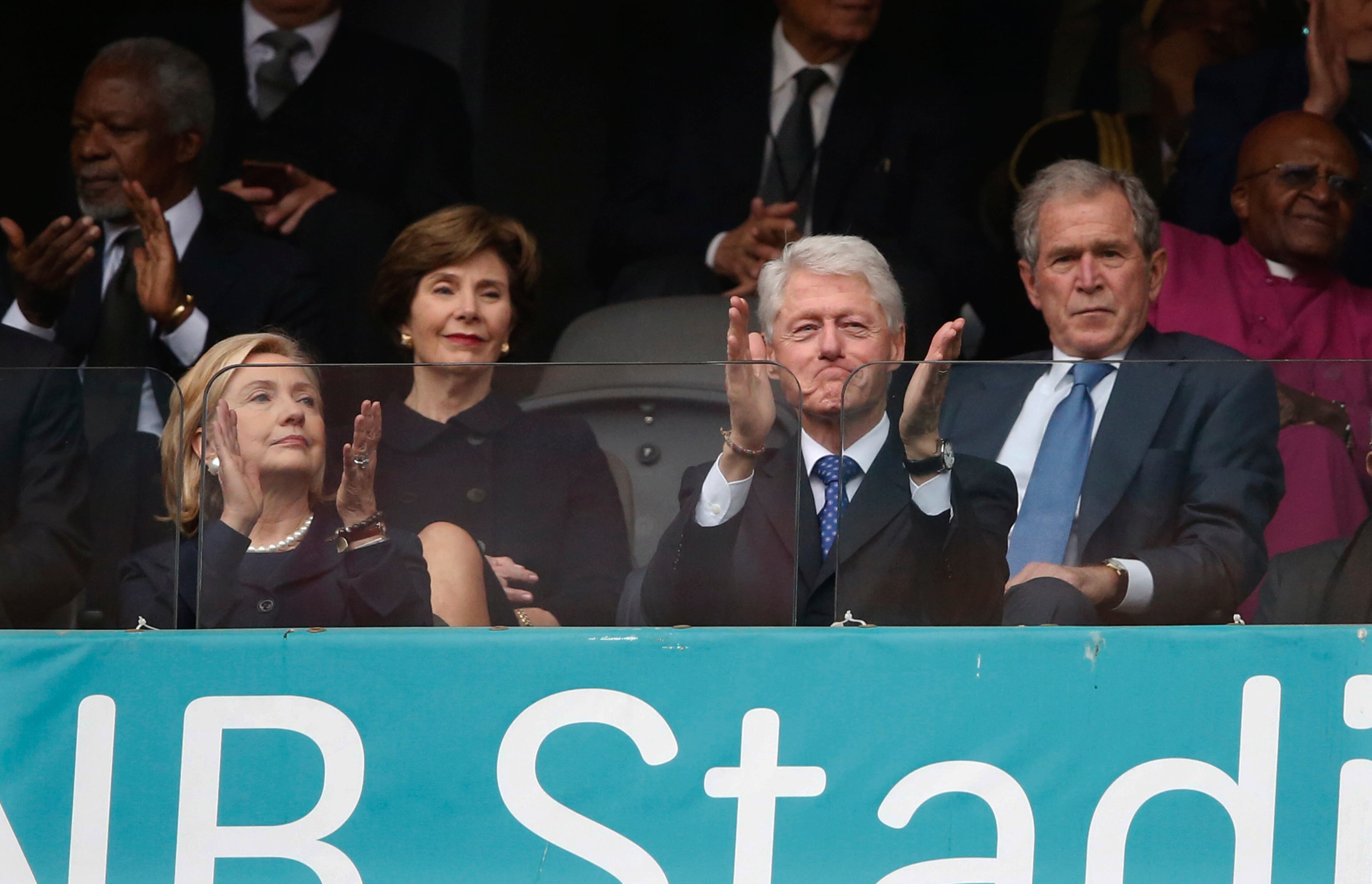 From left, Former U.S. Secretary of State Hillary Rodham Clinton, Laura Bush, Former U.S. President Bill Clinton and Former U.S. President George W. Bush listen to speakers during the memorial service for former South African president Nelson Mandela at the FNB Stadium in Soweto near Johannesburg, Tuesday, Dec. 10, 2013.