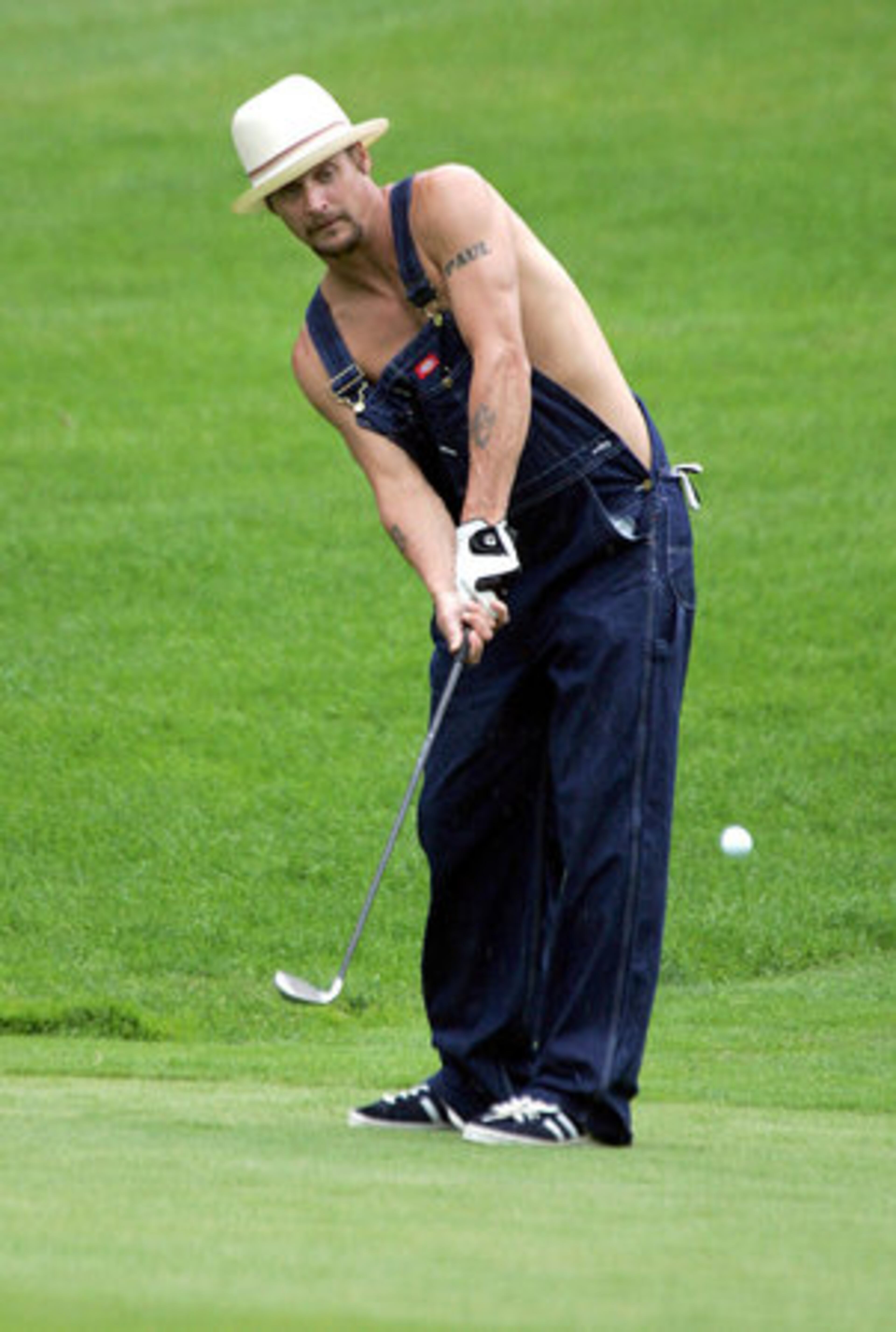 Dressed for golf (not!), musician Kid Rock chips on the 17th hole during the Buick Pro Am at Warwick Hills Golf and Country Club in Grand Blanc, Mich., Wednesday.