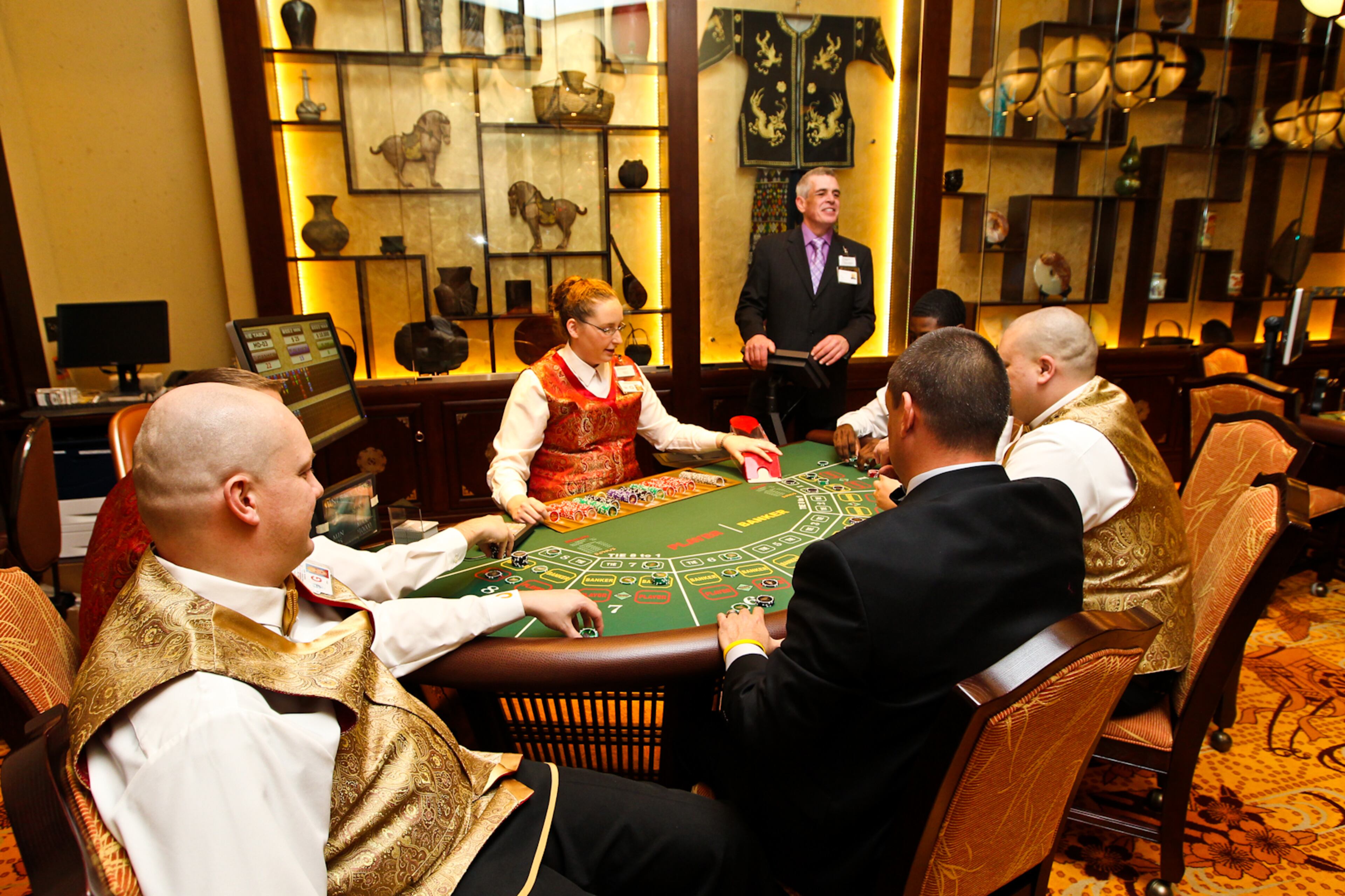 Dealers practice in a unique Asian Gaming Room inside the Horseshoe Casino's High Limit Room. The room features three Mini-Baccarat tables and is themed to pay homage to Chinese culture and tradition specific to Cincinnati's sister city, Liuzhou, China. The casino will open its doors to the public on March 4. NICK DAGGY / STAFF