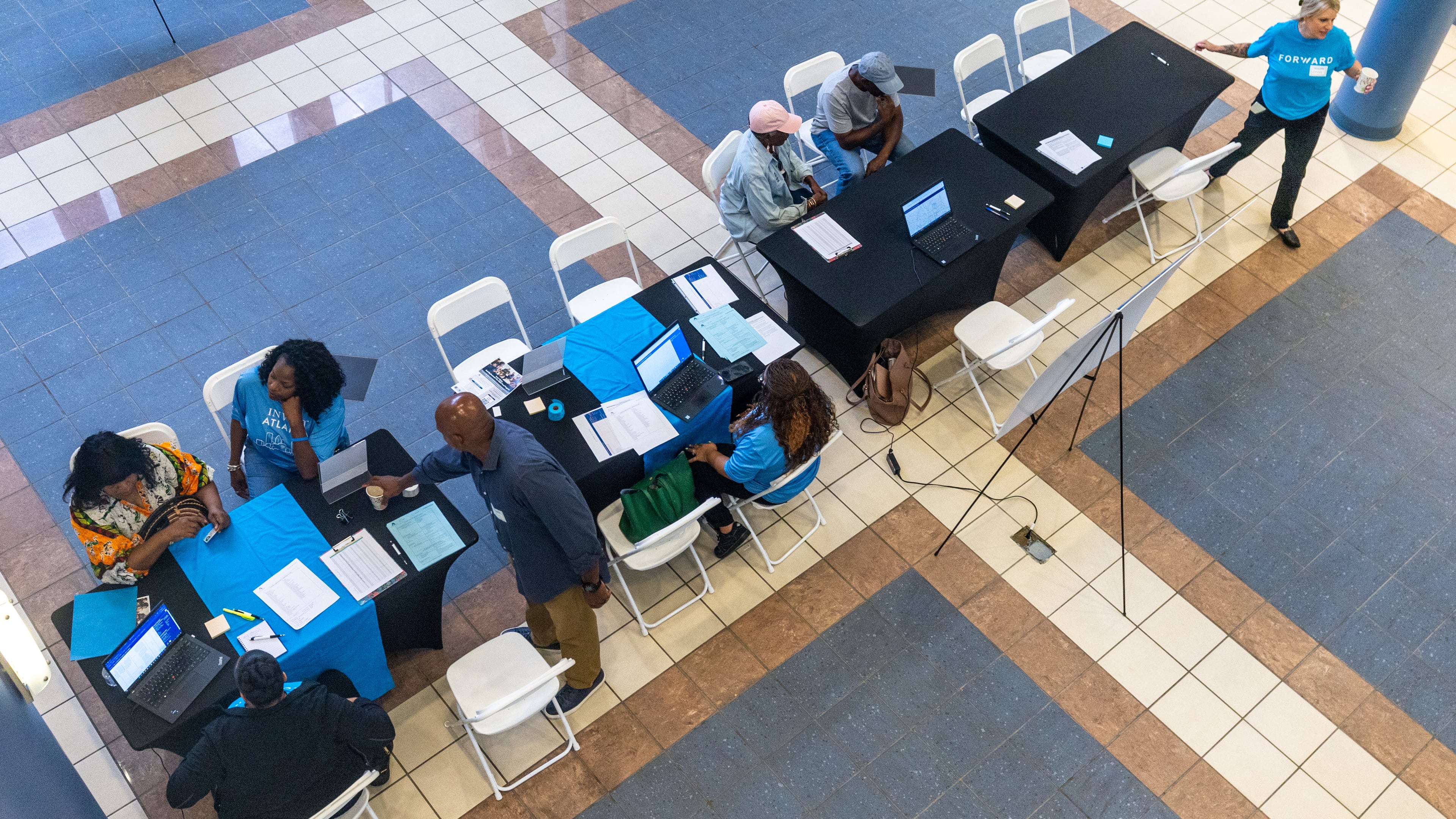 Volunteers help participants during the application assistance session at Atlanta Metro State College on Tuesday, Aug 6, 2024, apply for the anti-displacement tax relief fund program. (Steve Schaefer / AJC)