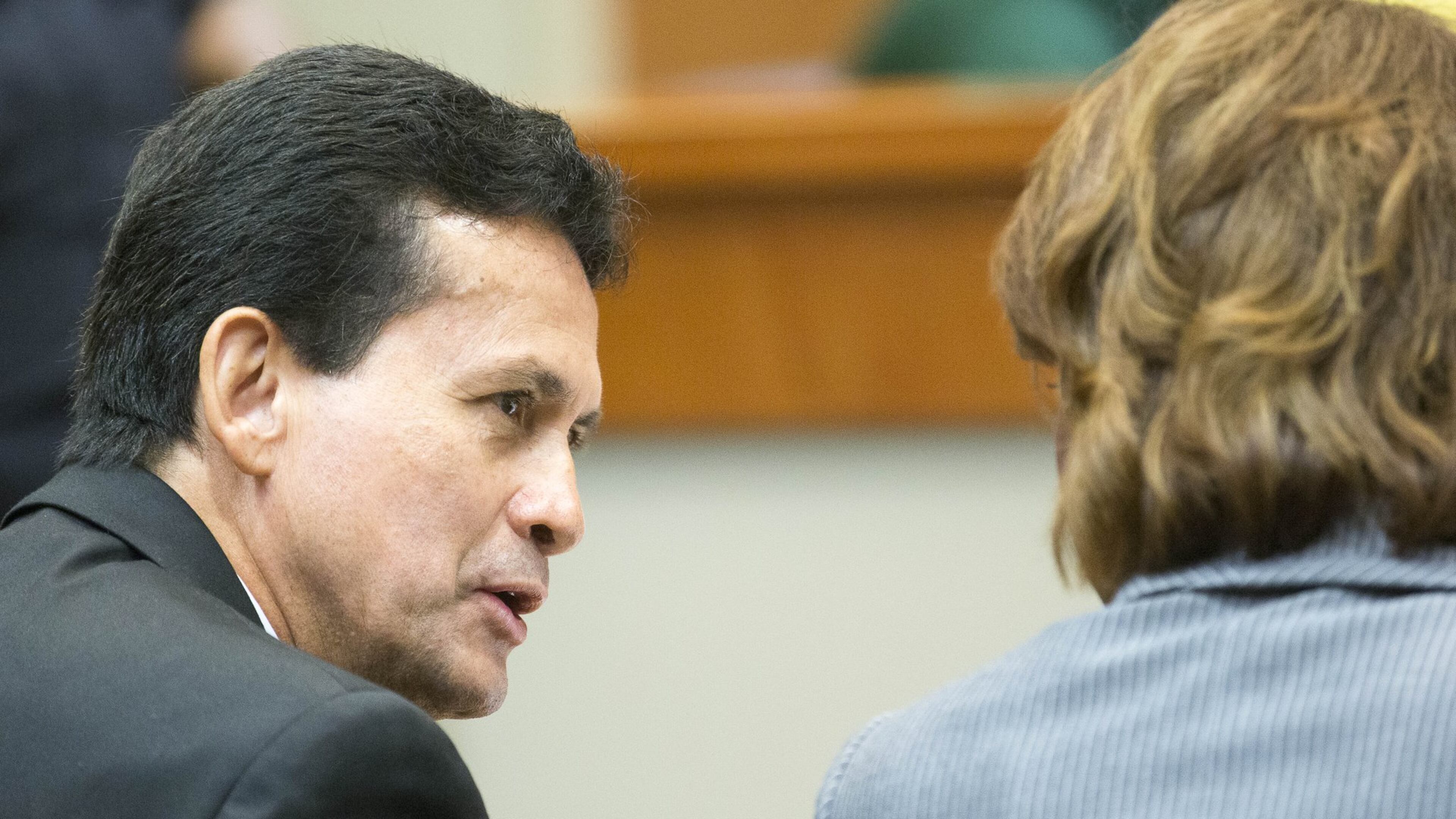 Dr. José Rios speaks with one of his defense attorneys, Laila Kelly, during his sexual battery trial on Thursday. On Friday, a DeKalb County jury aquitted him of both counts. ALYSSA POINTER/ALYSSA.POINTER@AJC.COM