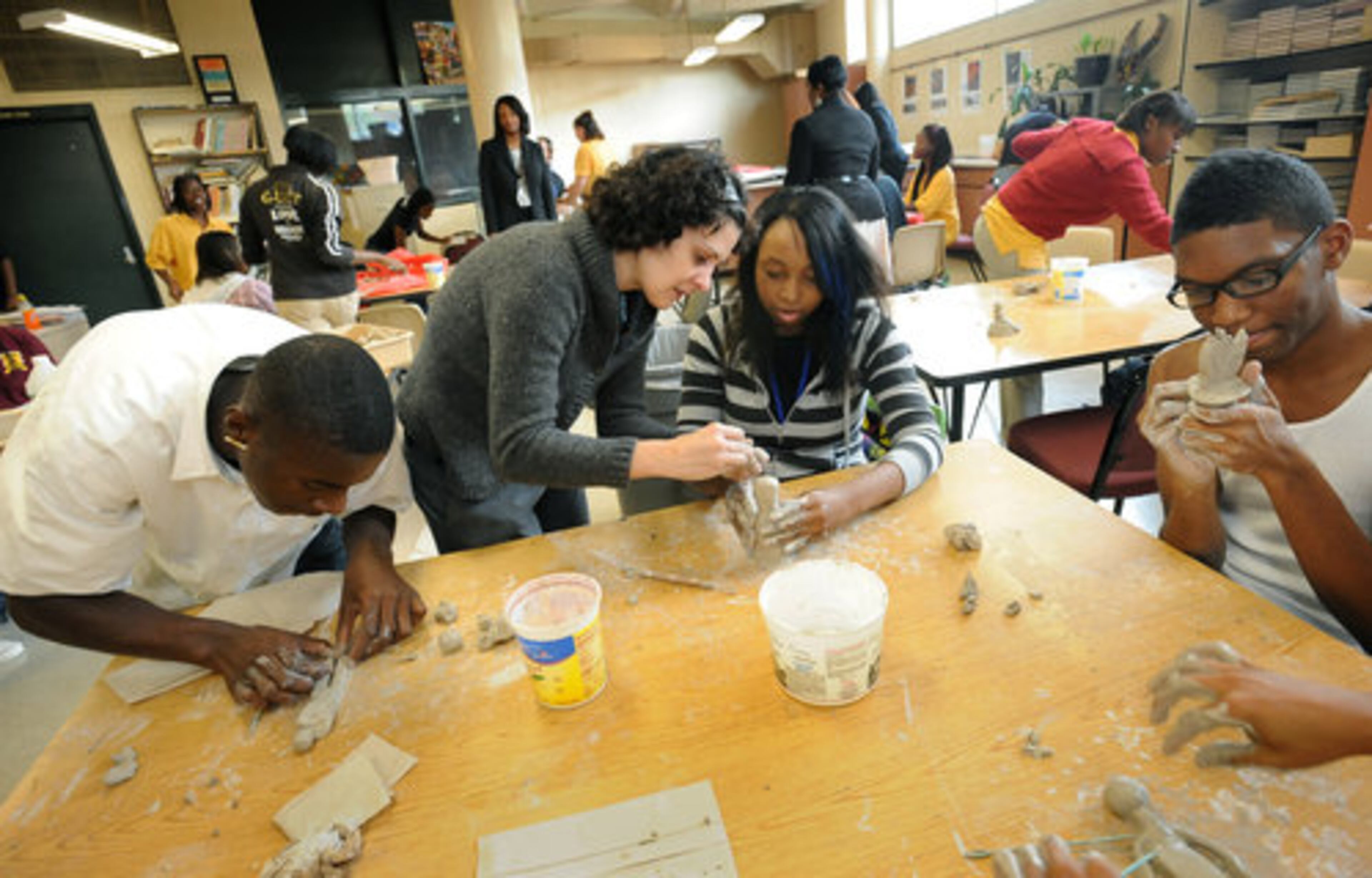 Jackie Keeler (second from left), English teacher, instructs Jermaine Wright (third from left), 16, as Diamond Ware (left), and Bernadette Mitchell (right), 16, work on their art works during arts class at Southside.