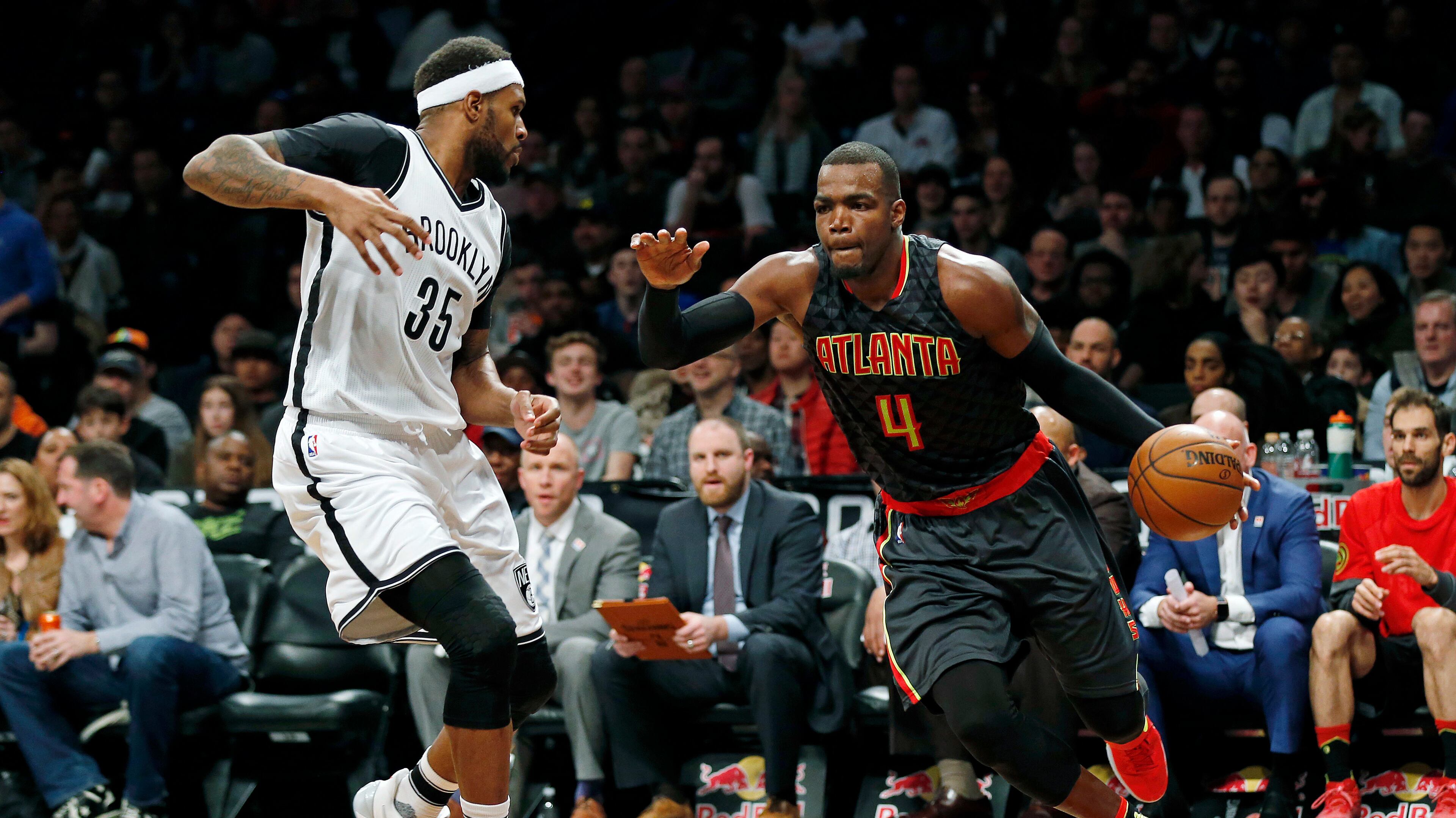 Atlanta Hawks forward Paul Millsap (4) drives to the basket past Brooklyn Nets forward Trevor Booker (35) during the second half of an NBA basketball game Sunday, April 2, 2017, in New York. The Nets won 91-82. (AP Photo/Adam Hunger)